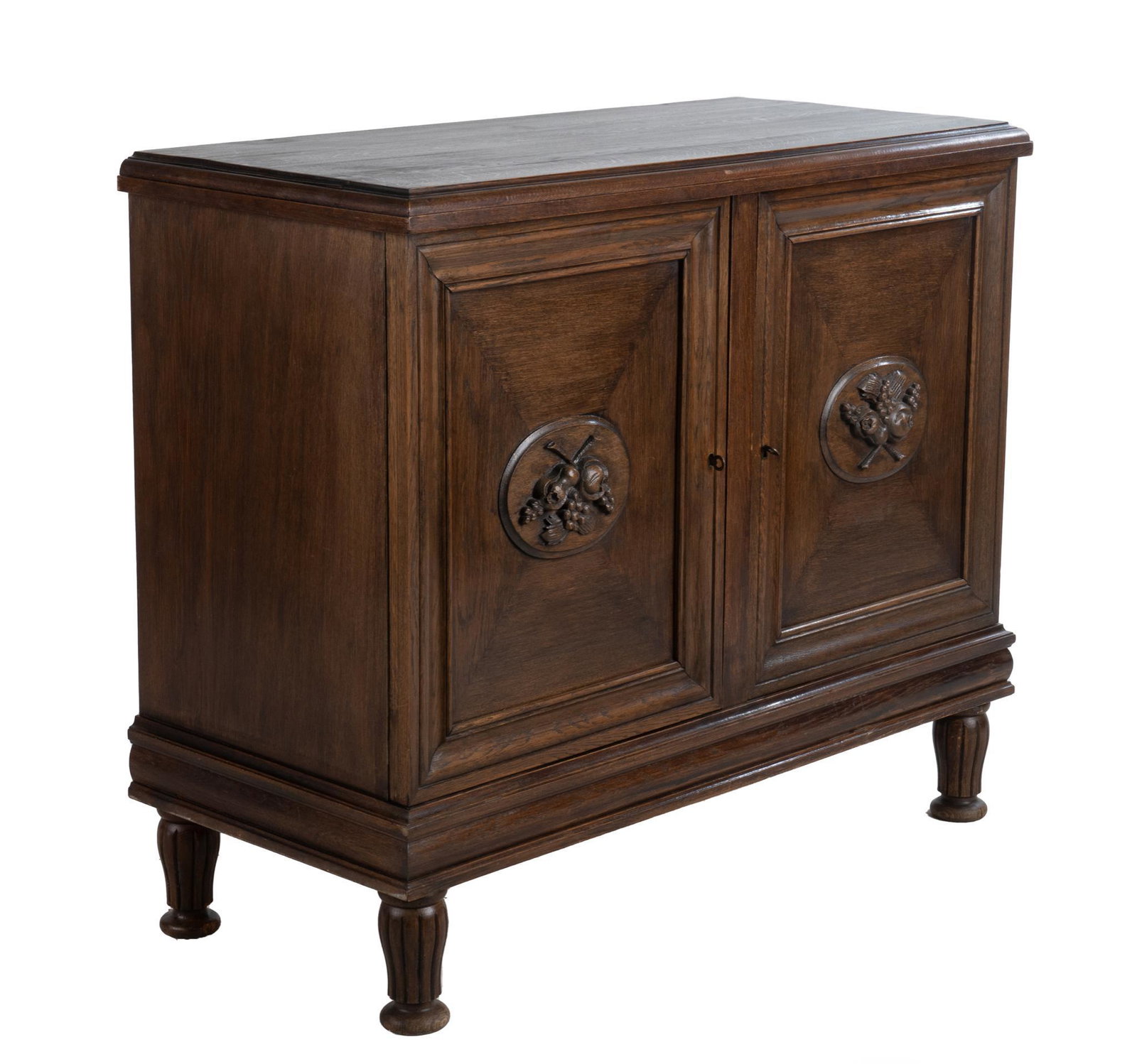 19th Century Italian Renaissance Style Desserte: 19th century Italian Renaissance style desserte, oak, with twin cabinets opening to shelf storage, featuring fruit motif medallions on doors, supported on fluted legs and bun feet, includes keys 40"h 