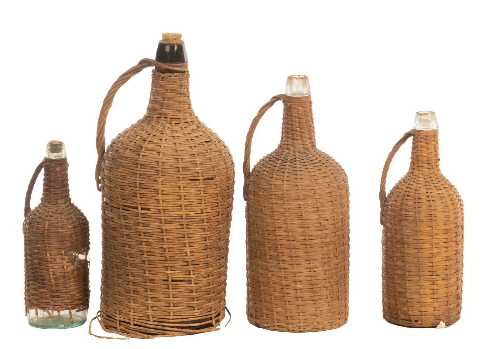 Collection of (4) Hand-Blown Glass Carboys: Wicker jackets, glass bottles 19"h x 8"w x 8"d / largest Provenance: An Alamo Heights, Texas collection We happily provide seamless shipping services on everything we sell. Please email us at shipping