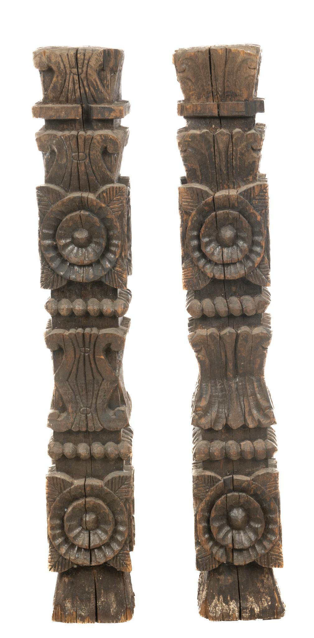 Pair of Carved Pillars: Pair of hand-carved wooden pillars, featuring rosette motif 44"h x 7"w x 7"d Provenance: A Bulverde, Texas collection We happily provide seamless shipping services on everything we sell. P