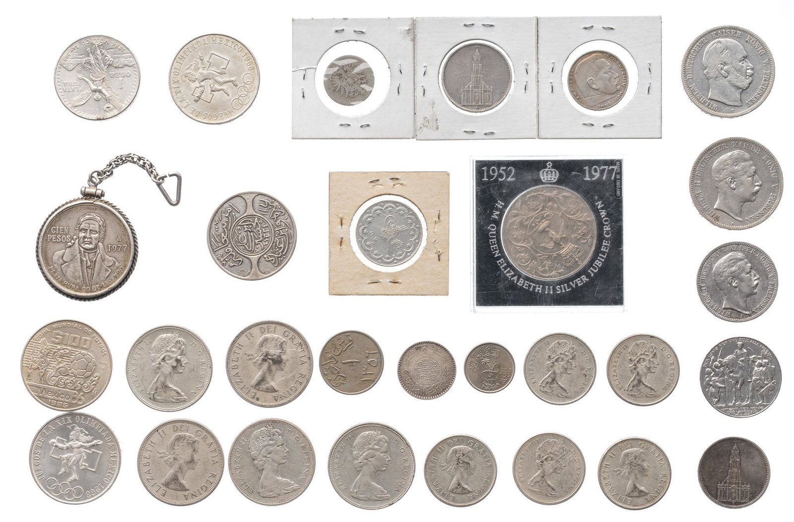 Mixed Foreign Silver Coins: Includes: Lot of Foreign silver coins, including Saudi Arabian Hejaz, Mexican Pesos, and Canadian silver dollars Provenance: The Estate of Doug King, Bandera, Texas We happily provide seamless shippin
