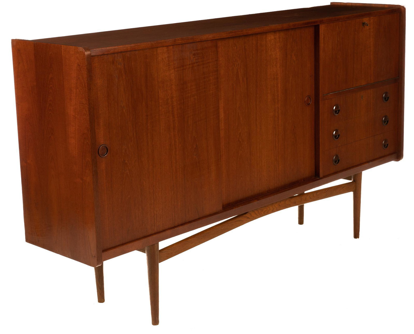 Danish Mid-Century Sideboard: Danish Mid-Century sideboard, having sliding doors, drop down cabinet door, above stack of drawers, rising on stretchered pin legs, to include key 49.5"h x 73"w x 16.5"d Condition: Scratches to door W