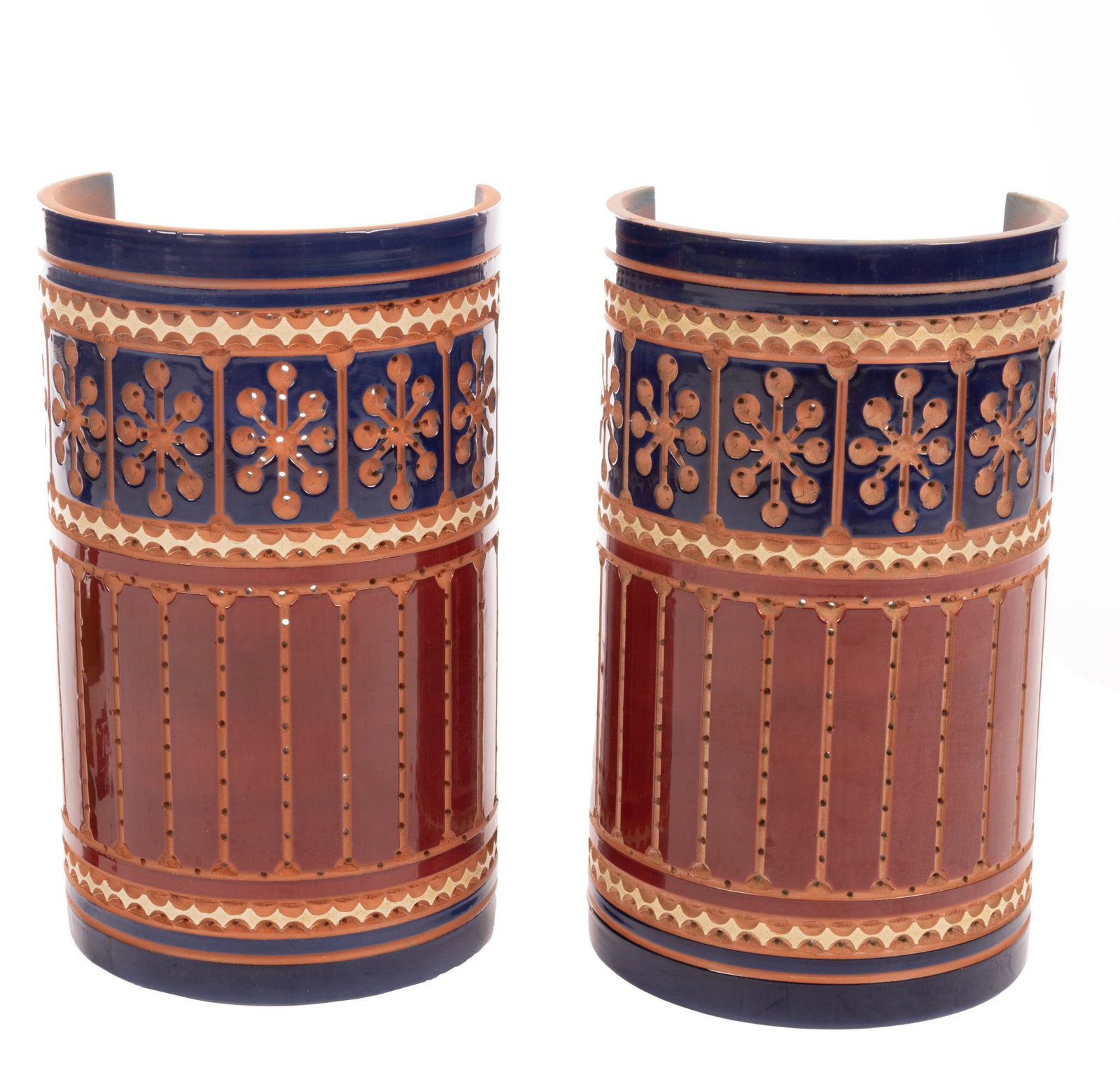 Pair of Beaumont Mood (San Antonio, TX) Light Sconces: Pair of matching vintage perforated ceramic pendant wall sconces by acclaimed San Antonio maker Beaumont Mood, having starburst accents, polychrome glazing 15"h x 9"w x 7"d Provenance: A San Antonio