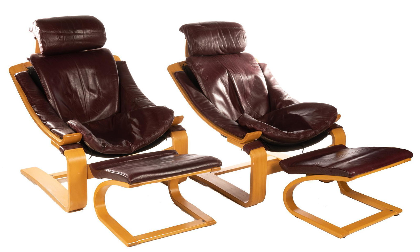 After Ake Fribytter, Pair of Mid-Century Bentwood Lounge Chairs with Ottomans: Matched pair of Mid-Century Kroken lounge chairs, each with matching foot stools or ottomans, having leather seats within bentwood frame, after famous design by Ake Fribytter for Nelo, Sweden 37"h x 3