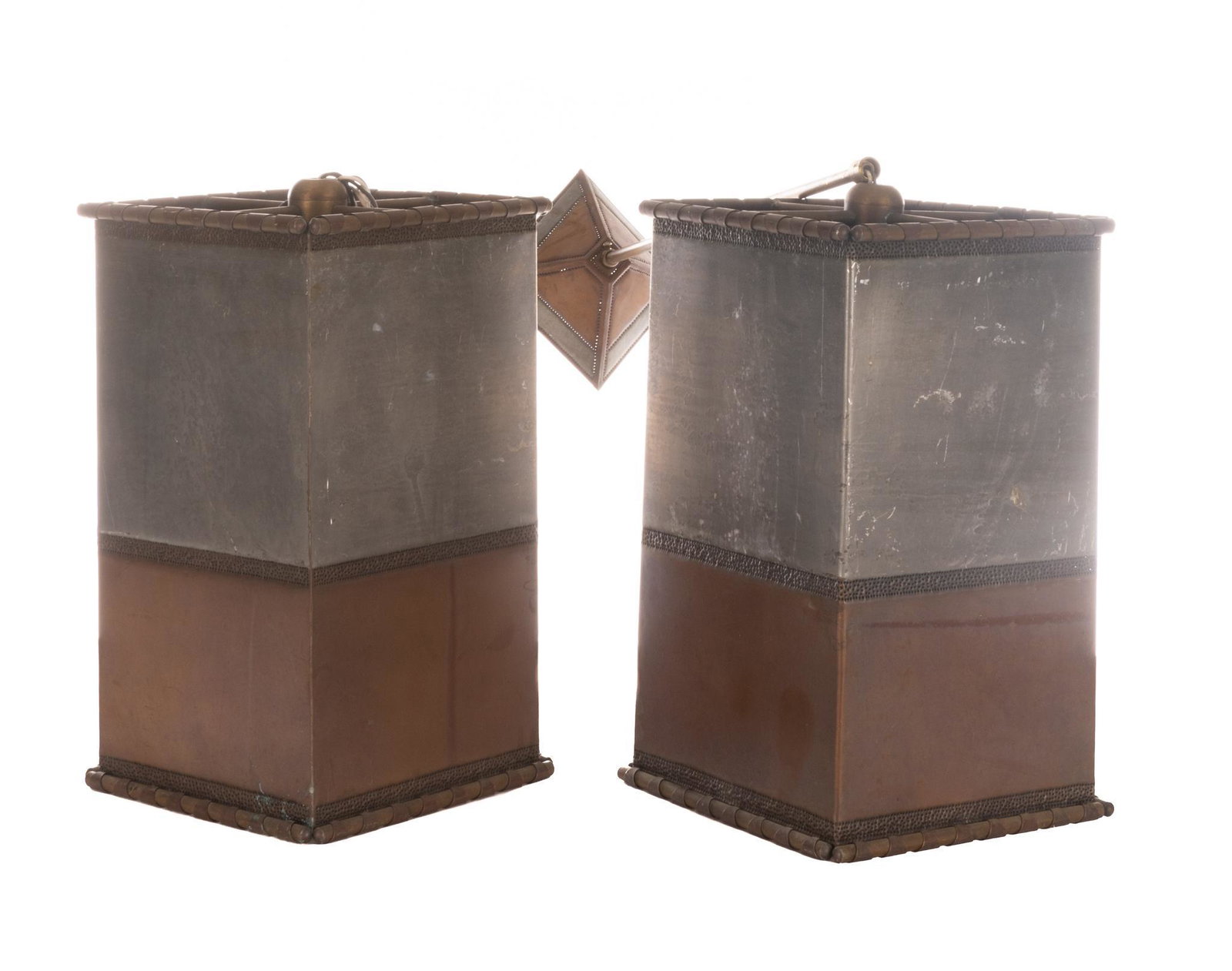 Isaac Maxwell (San Antonio, TX) Pair of Light Fixtures: Isaac Maxwell (San Antonio, TX), pair of matching punched metal light fixtures, having copper and tin dual toned body, to include wiring The spectacle of intricately patterned silhouette lighting is a
