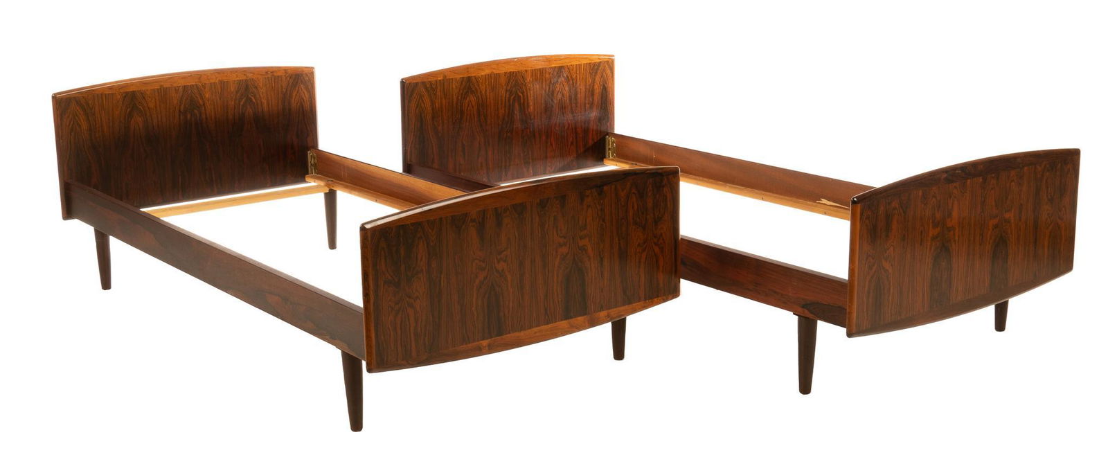 Pair of Danish Mid-Century Children's Beds: Pair of matching Danish Mid-Century childrens beds, having veneered headboard and footboard, supported on pin legs 26"h x 76.5"w x 37"d We happily provide seamless shipping services on everything w