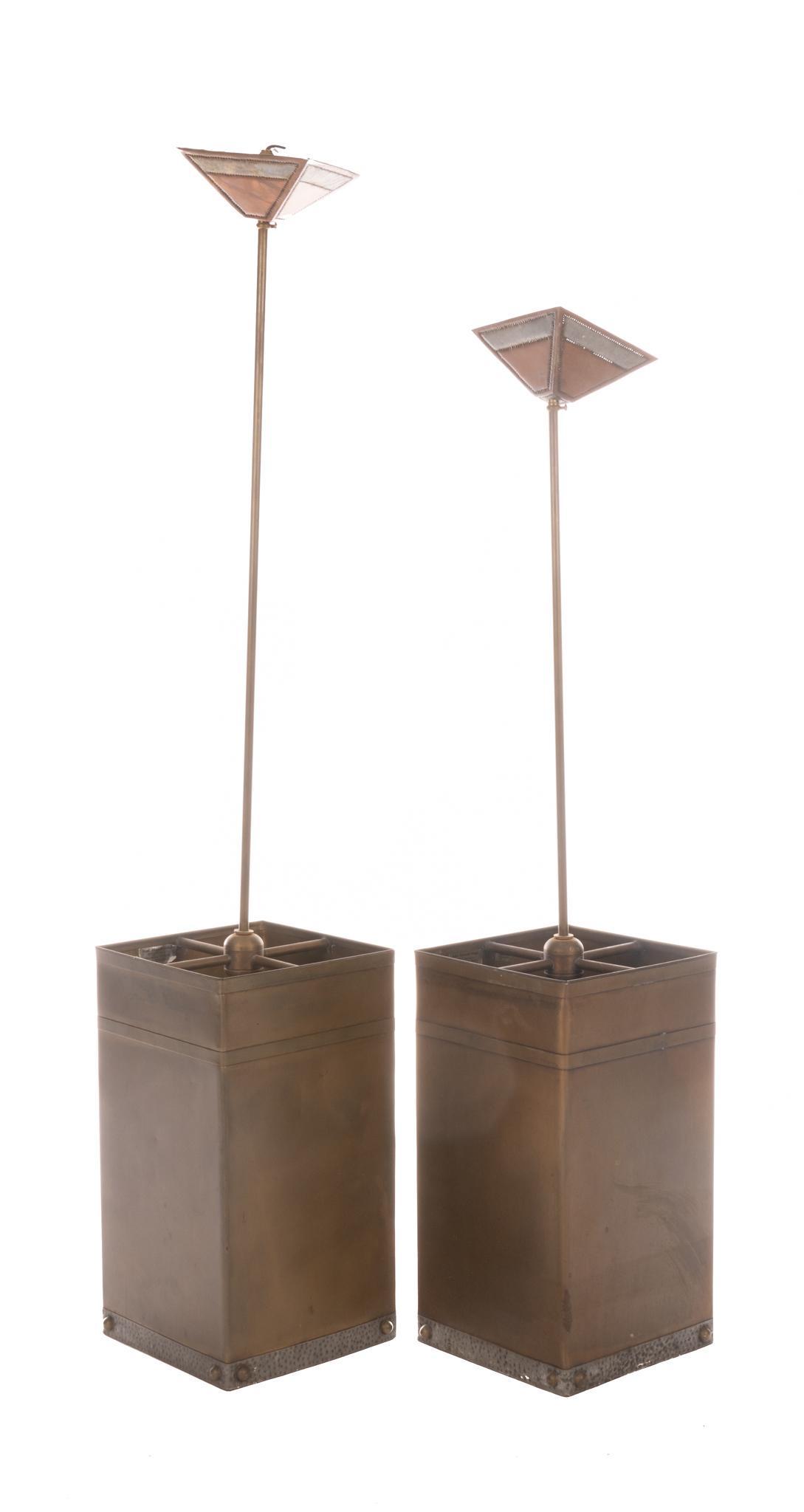 Isaac Maxwell (San Antonio, TX) Pair of Light Fixtures: Isaac Maxwell (San Antonio, TX), pair of matching hanging light pendants, having copper body, hammered metal trim, to include wiring The spectacle of intricately patterned silhouette lighting is a dis