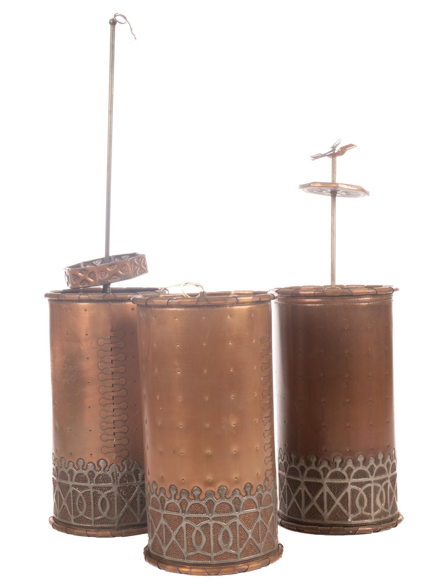 Isaac Maxwell (San Antonio, TX) Set of (3) Hanging Light Fixtures: Isaac Maxwell (San Antonio, TX), pair of matching hanging light pendants, having copper body, punched accents, brass lattice The spectacle of intricately patterned silhouette lighting is a distinctive