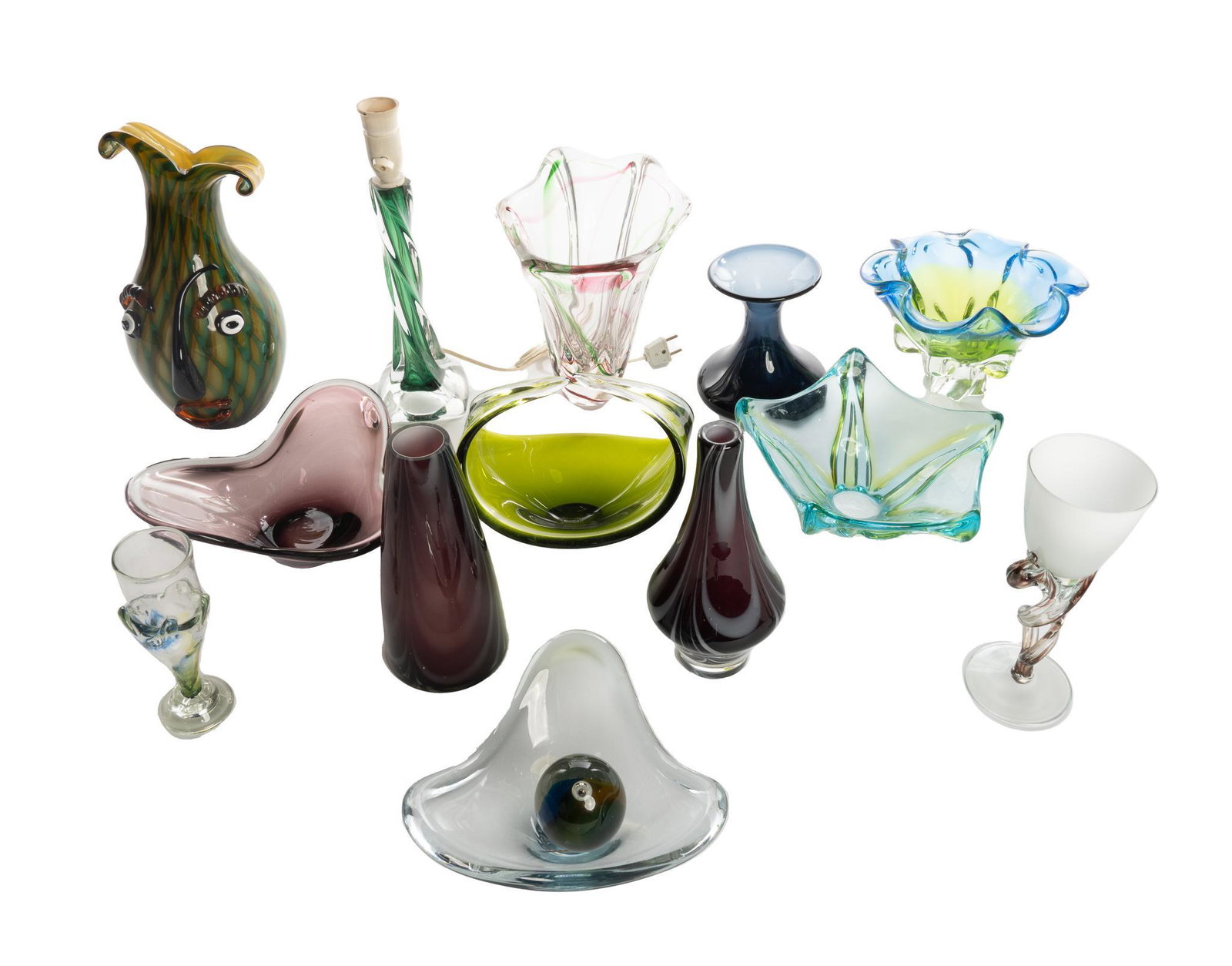 Collection of (13) Pieces of Mid-Century Art Glass: Collection of thirteen pieces of Mid-Century art glass, to include decorative dishes, lamp, goblet, featuring anthropomorphic vase 14.5"h x 4.5"w x 4.5"d Note: lamp has European wiring We happily prov