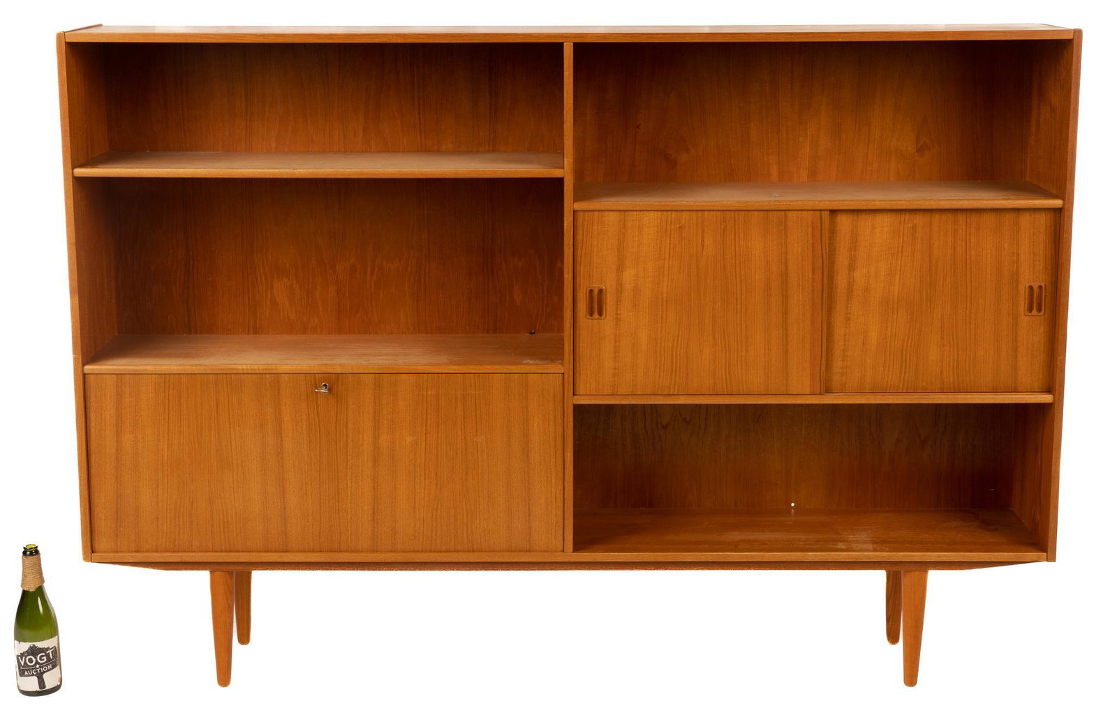 Danish Mid-Century Sideboard: Danish Mid-Century sideboard, having open shelves, sliding doors, drop down door, leading to interior shelves, rising on tapered legs 51"h x 75"w x 12"d We happily provide seamless shipping services o