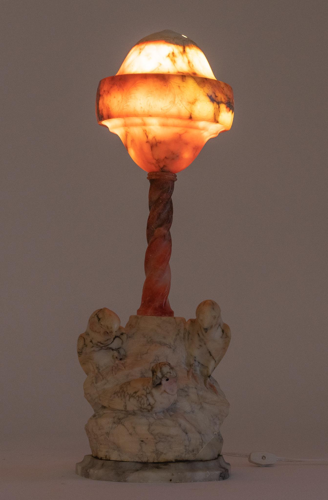 Carved Marble Table Lamp: Carved marble table lamp. featuring pink globe shade, supported on twisted column, ending in marble base, featuring carved parakeets, signed "Made in Italy" 22"h x 7.5"w x 7.5"d Pr