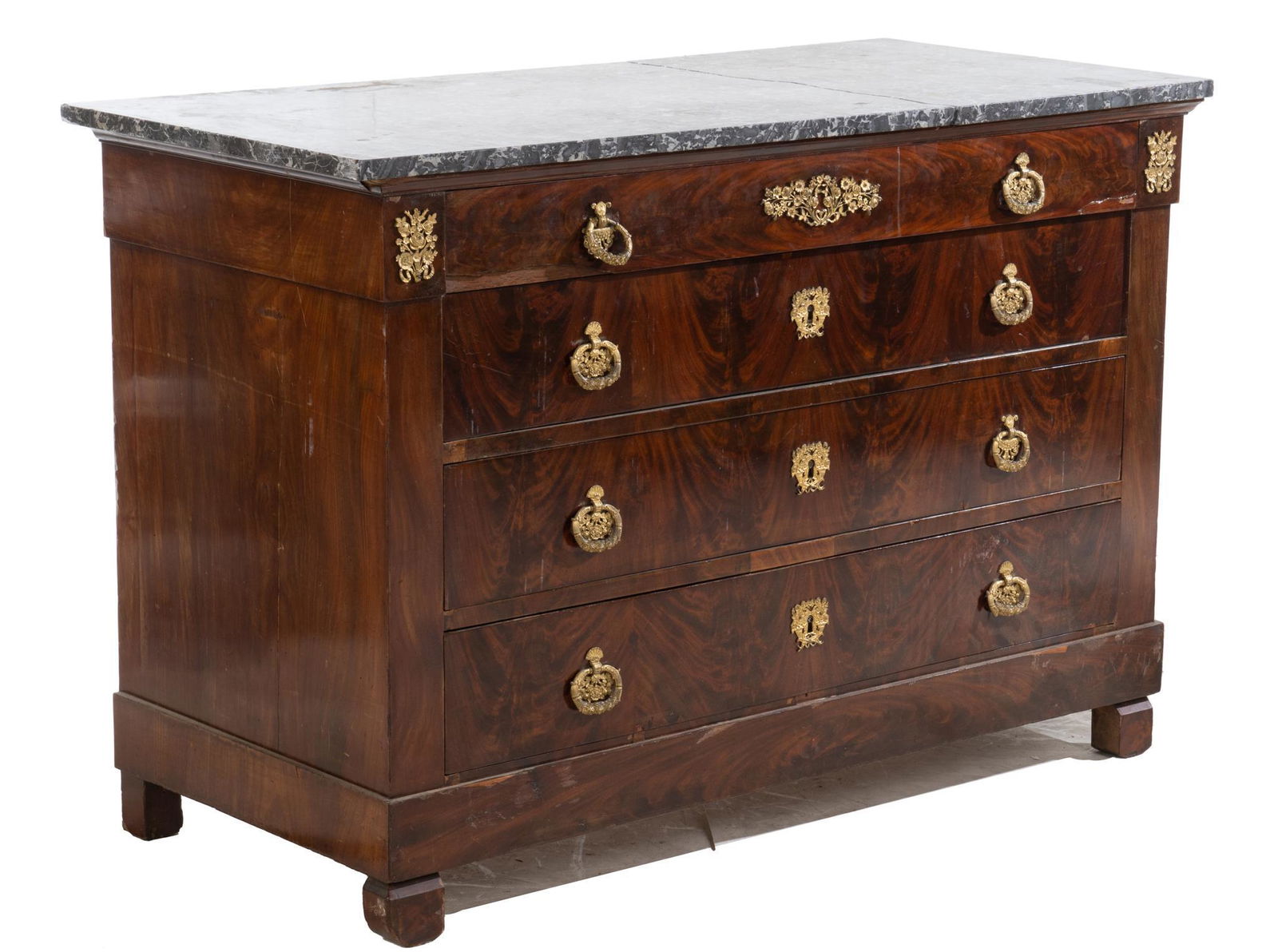 French Empire-style Commode: French Empire-style commode, having marble top above fruitwood case containing single frieze drawer above three stacking drawers, adorned with ormolu detailing and heavy brass escutcheon and raised on