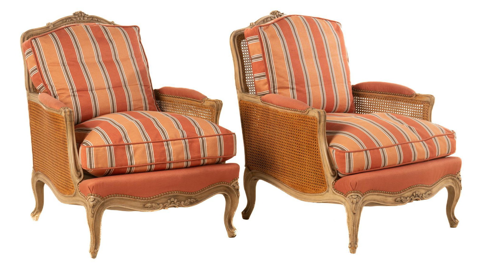Pair of Louis XV-Style Bergere Armchairs: Pair of matching Louis XV style bergere armchairs, having carved wooden frame with woven back and sides, featuring floral motif, rising on cabriole legs 36"h x 28.5"w x 31"d Note: Matching