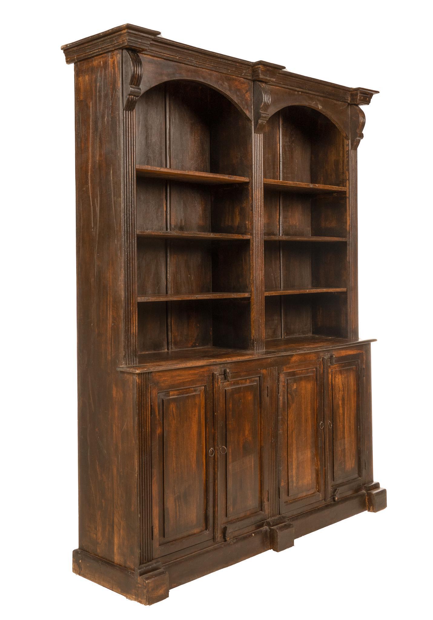 Library Bookcase: Federal-style open library bookcase, having six open shelves across two compartments flanked by columnar supports, above four doors that open to shelved interior 90"h x 67"w x 20"d Conditi