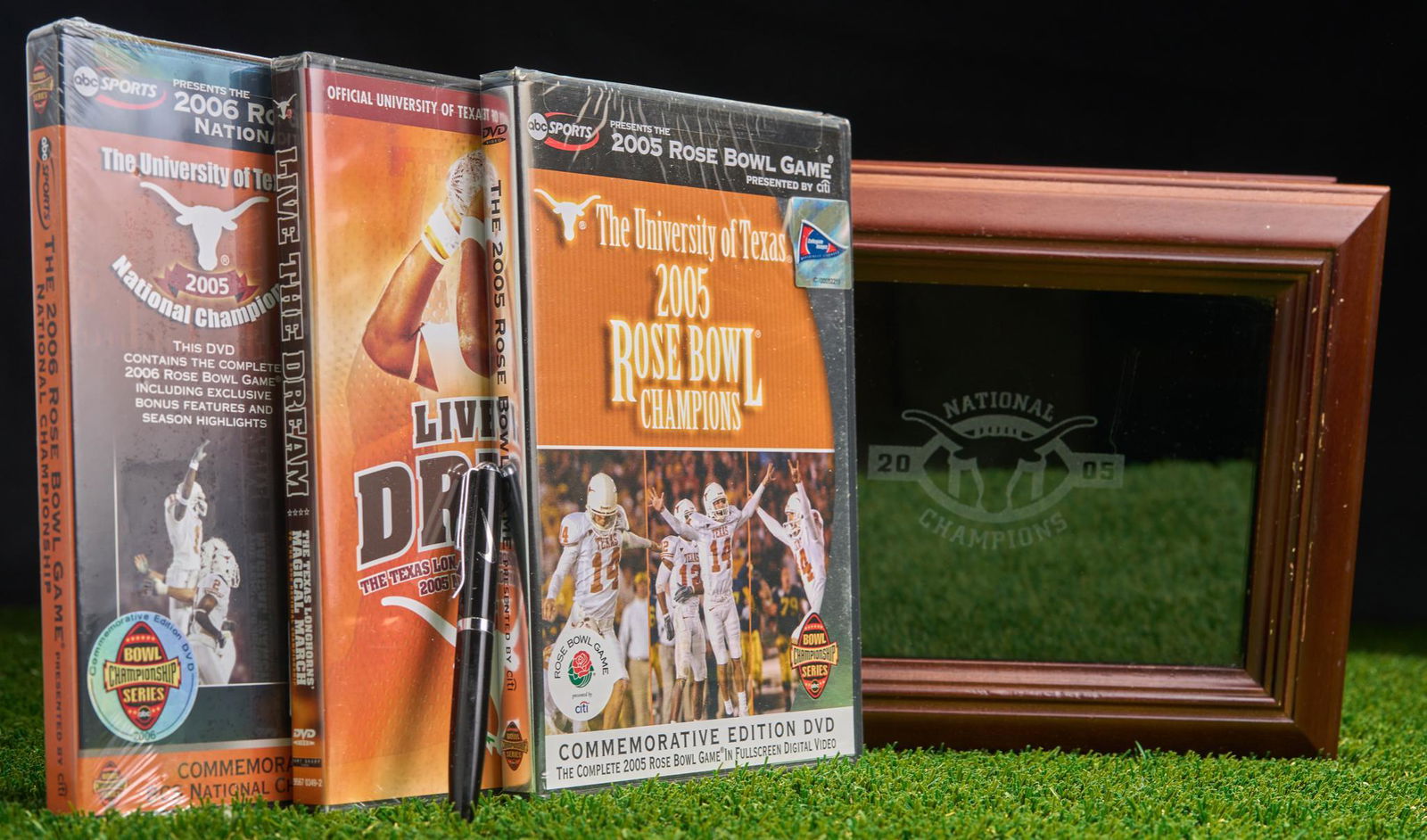 Set of 3 University of Texas DVD's and 2005 UT Championship Box: Wood 2005 University of Texas Championship box with 3 DVD's and Nike pen. The DVD's are 2005 University of Texas Rose Bowl by ABC Sports, ABC Sports Commemorative Edition 'Live the Dream" 2006 UT seas
