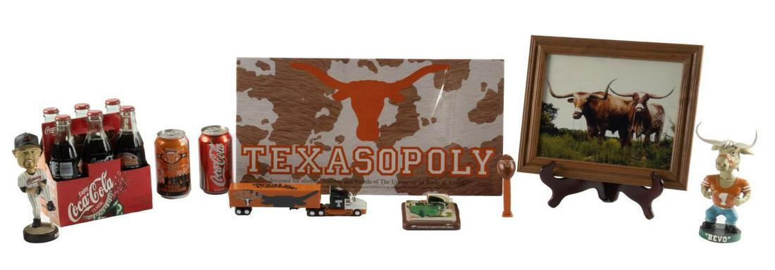 Collection of Sports Memorabilia from Larry Falk: Items collected by Larry Falk including a Texasolopy game, Roger Clemens bobblehead, Disch-Falk field minature, BEVO bobblehead, 2 2005 UT National Champions coke cans, BEVO photo, Six pack of Coke bo