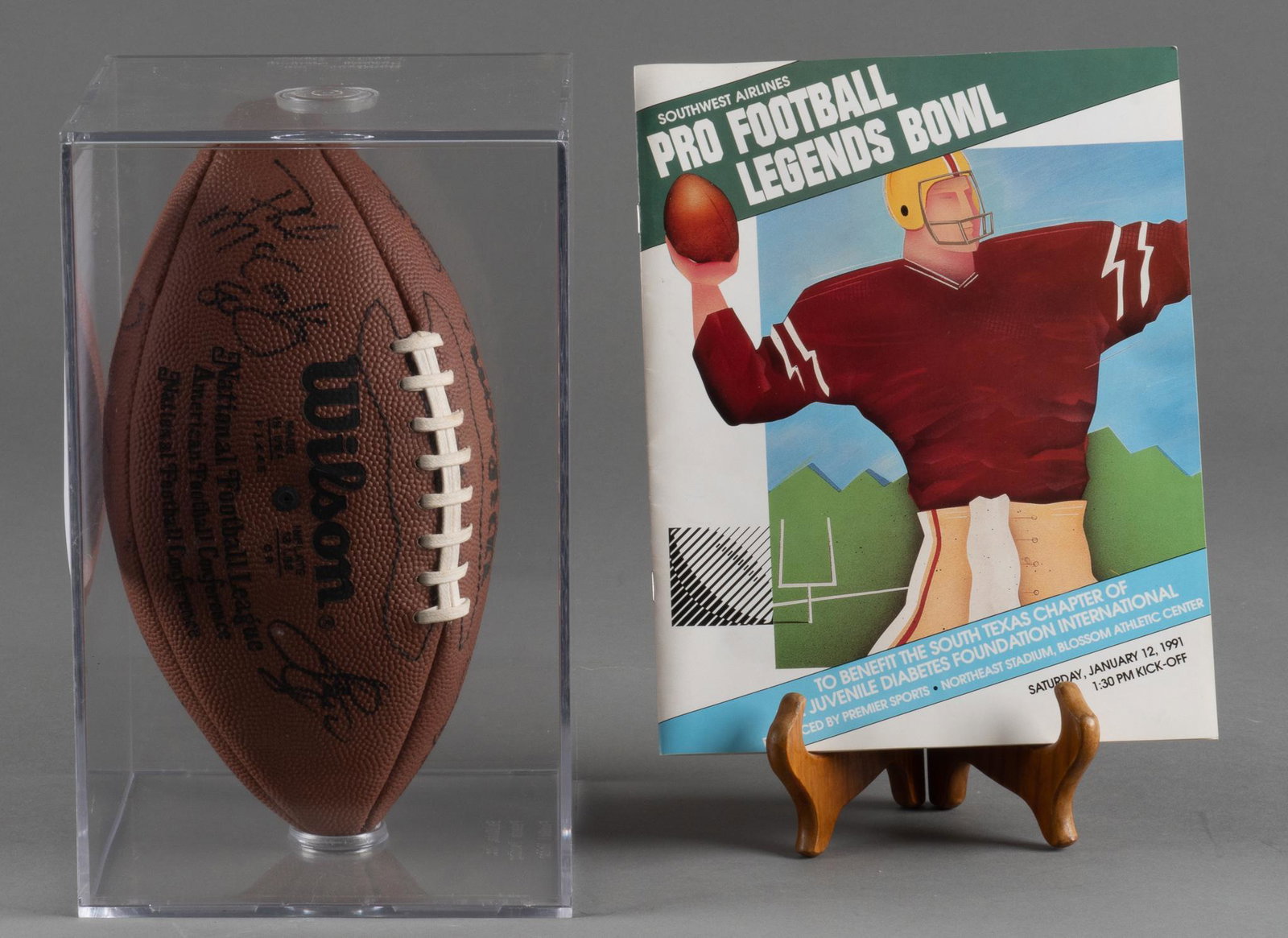Pro Football Legends Bowl Signed Football and Program: 1991 Pro Football Legends Bowl in San Antonio, TX football signed by Drew Pearson (Cowboys), Steve Watson (Broncos), Ed "Too Tall" Jones (Cowboys), Rick Upchurch (Broncos), Dave Casper (Raider