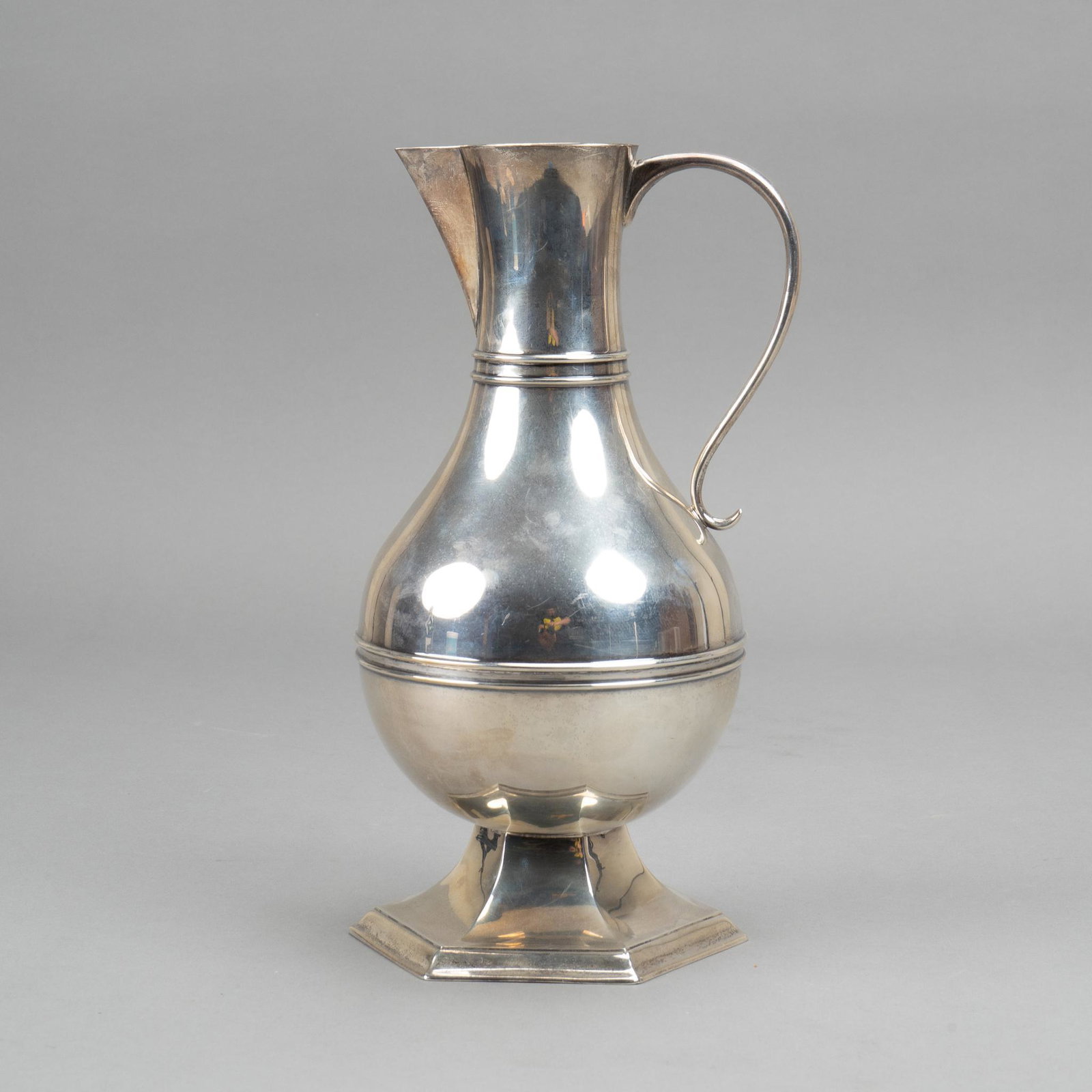 Art Moderne Sterling Silver Water Pitcher: Antique sterling silver water pitcher having wide flared base, bulbous body, delicate loop handle and angular spout. Height 11 1/4"; total weight 25.78 ozt Provenance: The collection of Bill and P