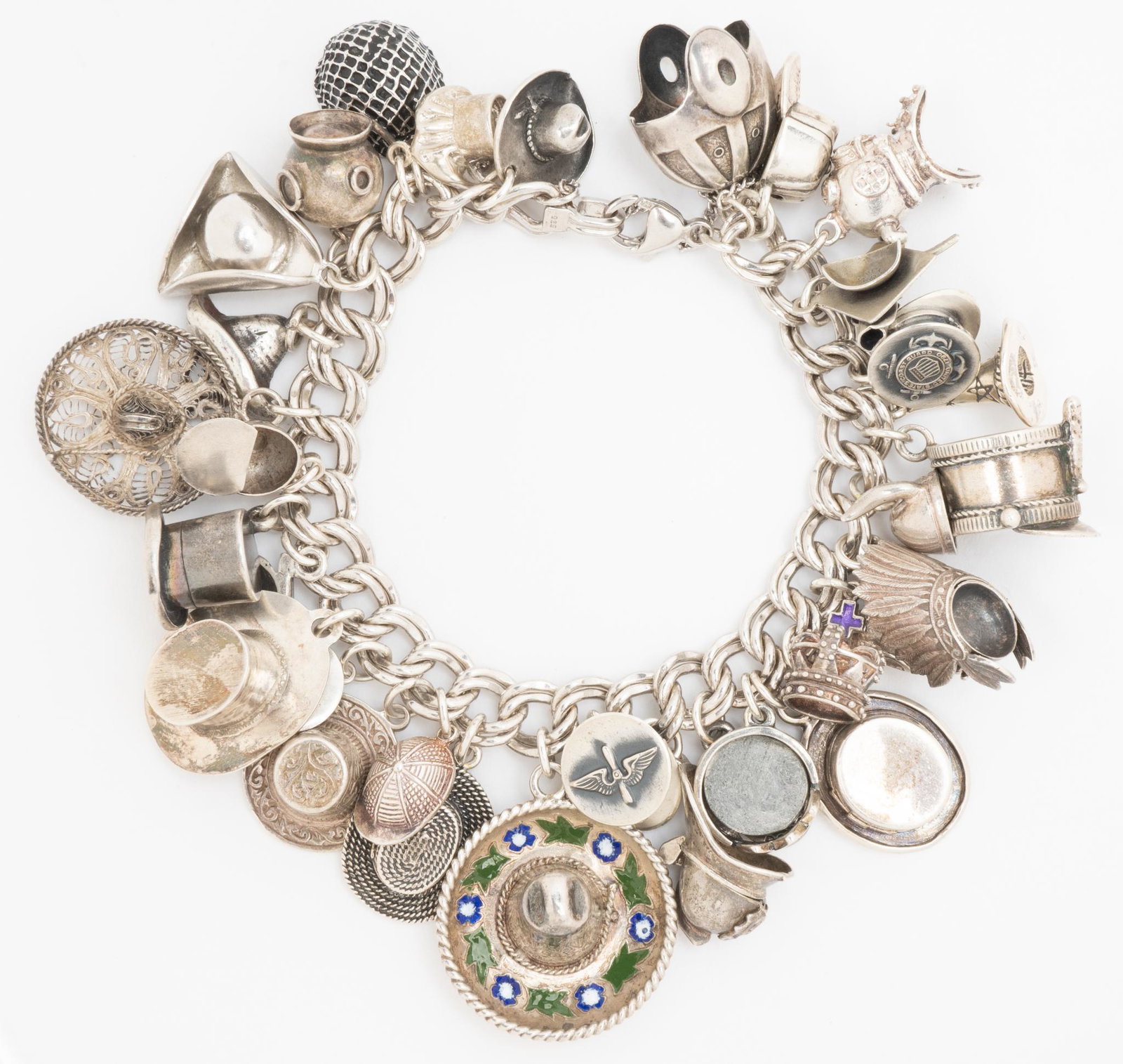 Vintage Sterling Silver Hats Charm Bracelet: Vintage James Avery sterling charm wide double curb link bracelet with approximately 32 sterling silver hat charms, from various makers (a couple may not be sterling). Charms length from 1/2" to 3