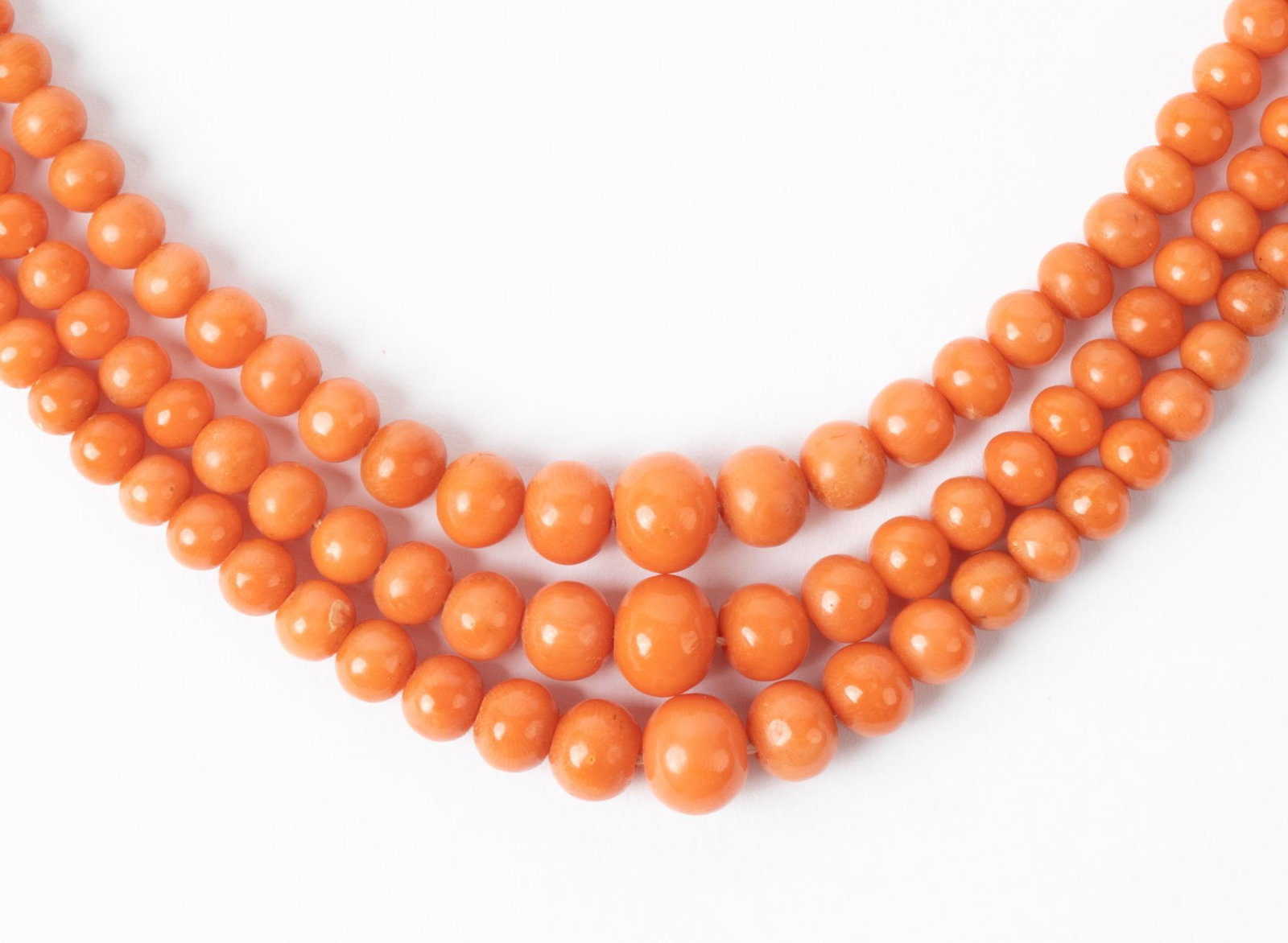Antique Salmon Coral Bead Necklace: Antique natural salmon coral bead (3mm to 8mm) triple strand necklace with rolled gold clasp. Necklace length 19"; total weight 54.2 grams Provenance: A San Antonio, Texas collection We happily pr