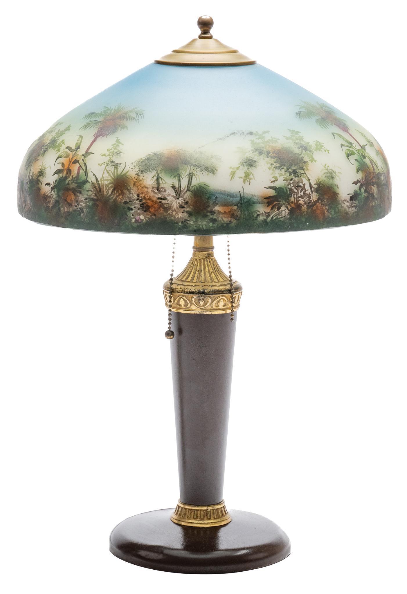 Hand-Painted Arts and Crafts Style Table Lamp: Arts and Crafts style table lamp, featuring hand-painted glass shade, supported on tapered wooden base, with gold toned accents, wiring in working condition 20h x 14dia. Provenance: A San Antonio,