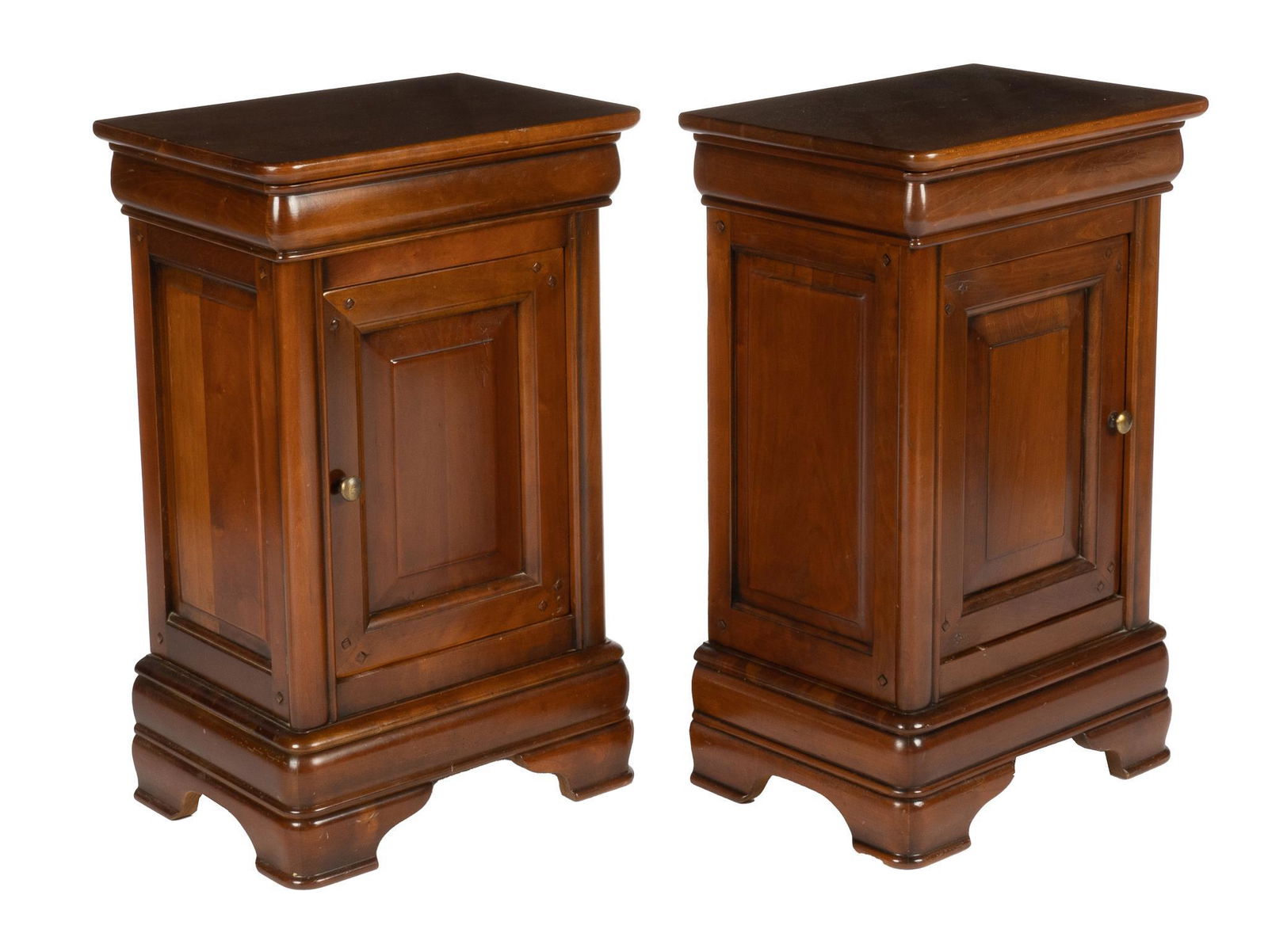 Pair of Louis Philippe Period Nightstands: Matching pair of Louis Philippe period wood nightstands, each with a single door with a metal pull opening to a single shelf interior, supported on ogee bracket feet 27.5h x 17.5w x 13d We happily p
