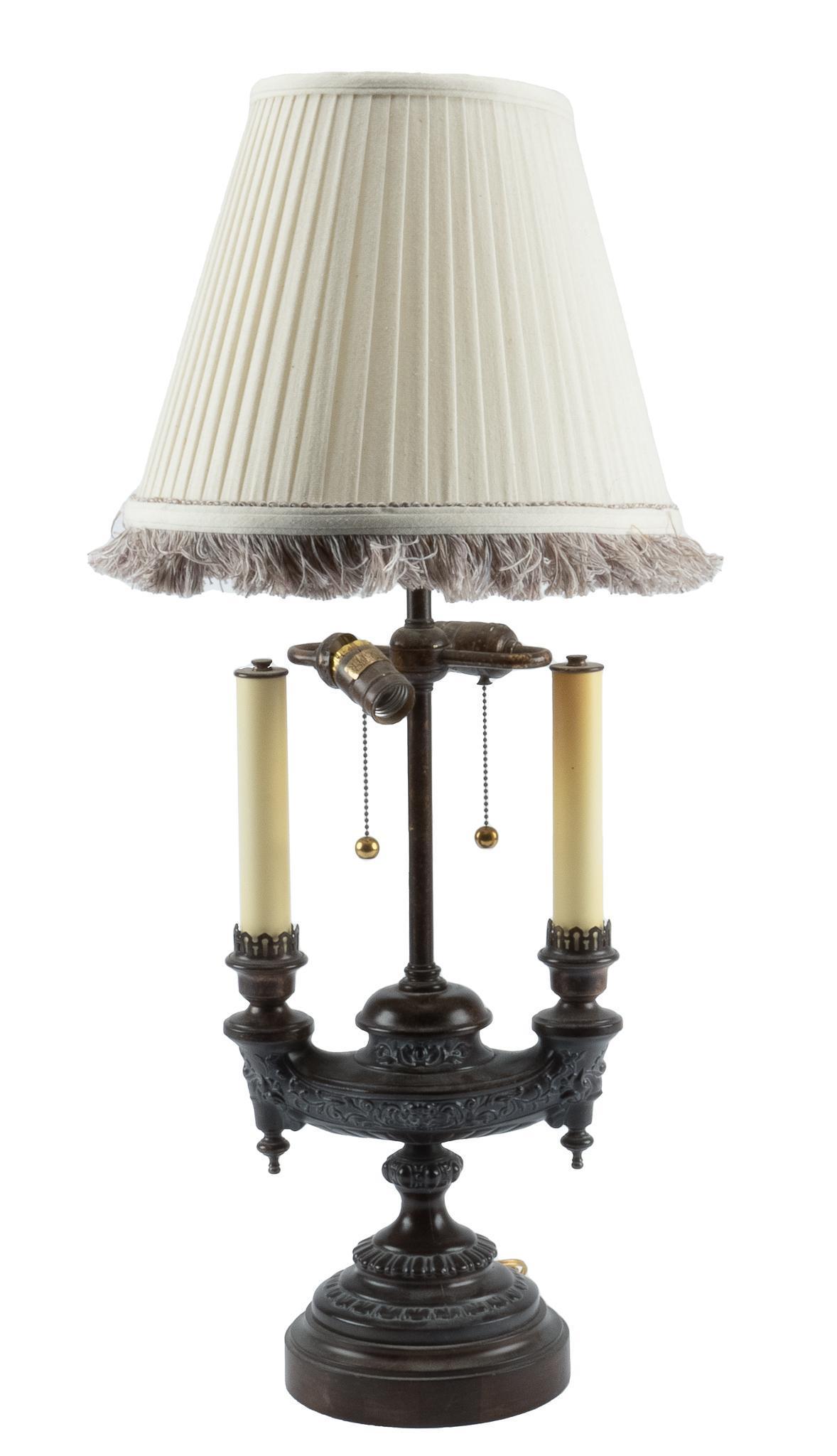 Frederick Cooper Bouillotte Lamp: Frederick Cooper bouillotte lamp, featuring dual faux candles, urn base, wiring in working condition, to include lamp shade 33h x 19w x 11d Condition: Tear in lamp shade Provenance: Property from a
