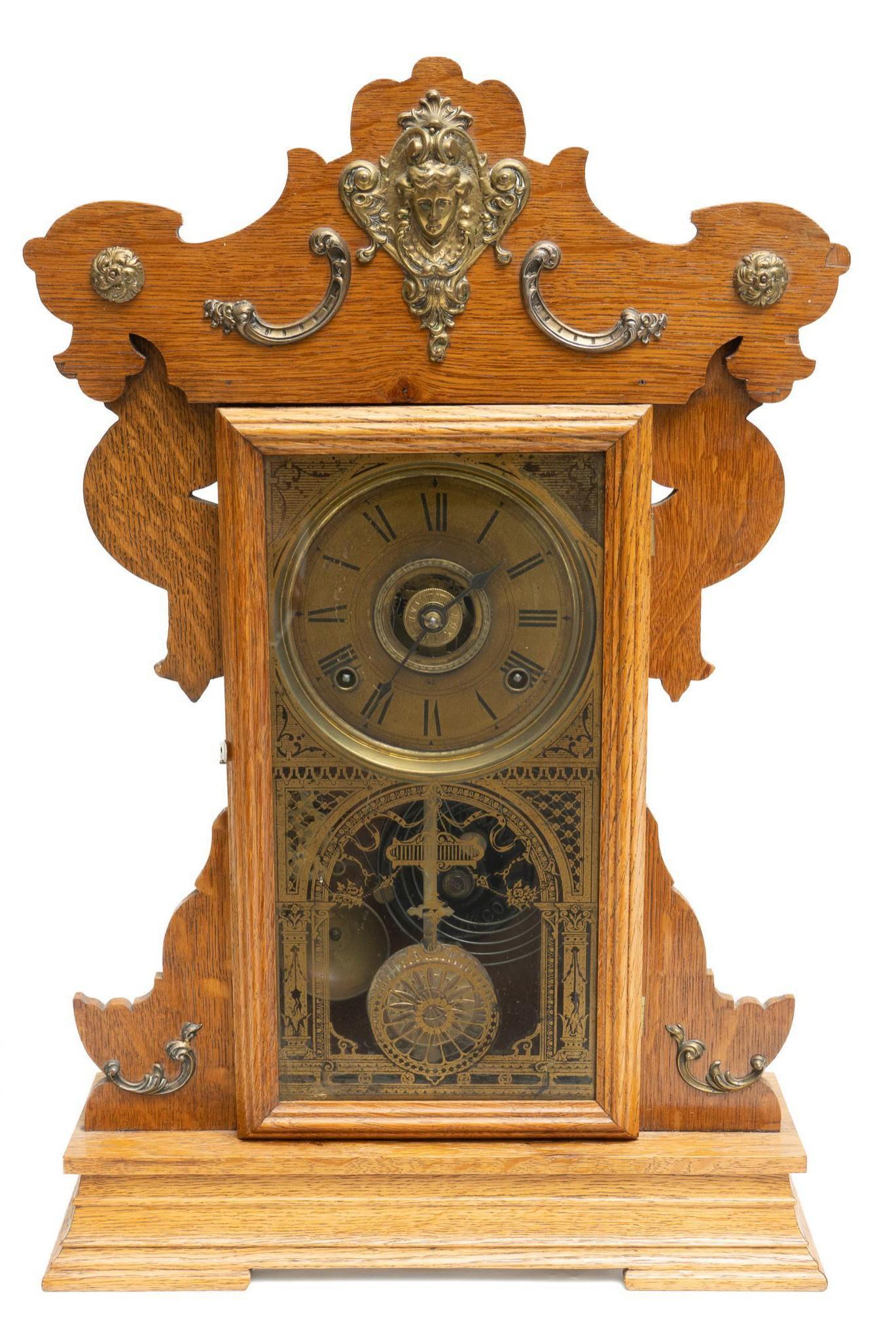 Seth Thomas Clock Co. Parlor Clock: Seth Thomas Clock Co. (Connecticut, USA) parlor clock, 8 day time, strike, and alarm movement, with carved gingerbread frame with glazed door that opens to brass movement 23"h x 15"w x 5"