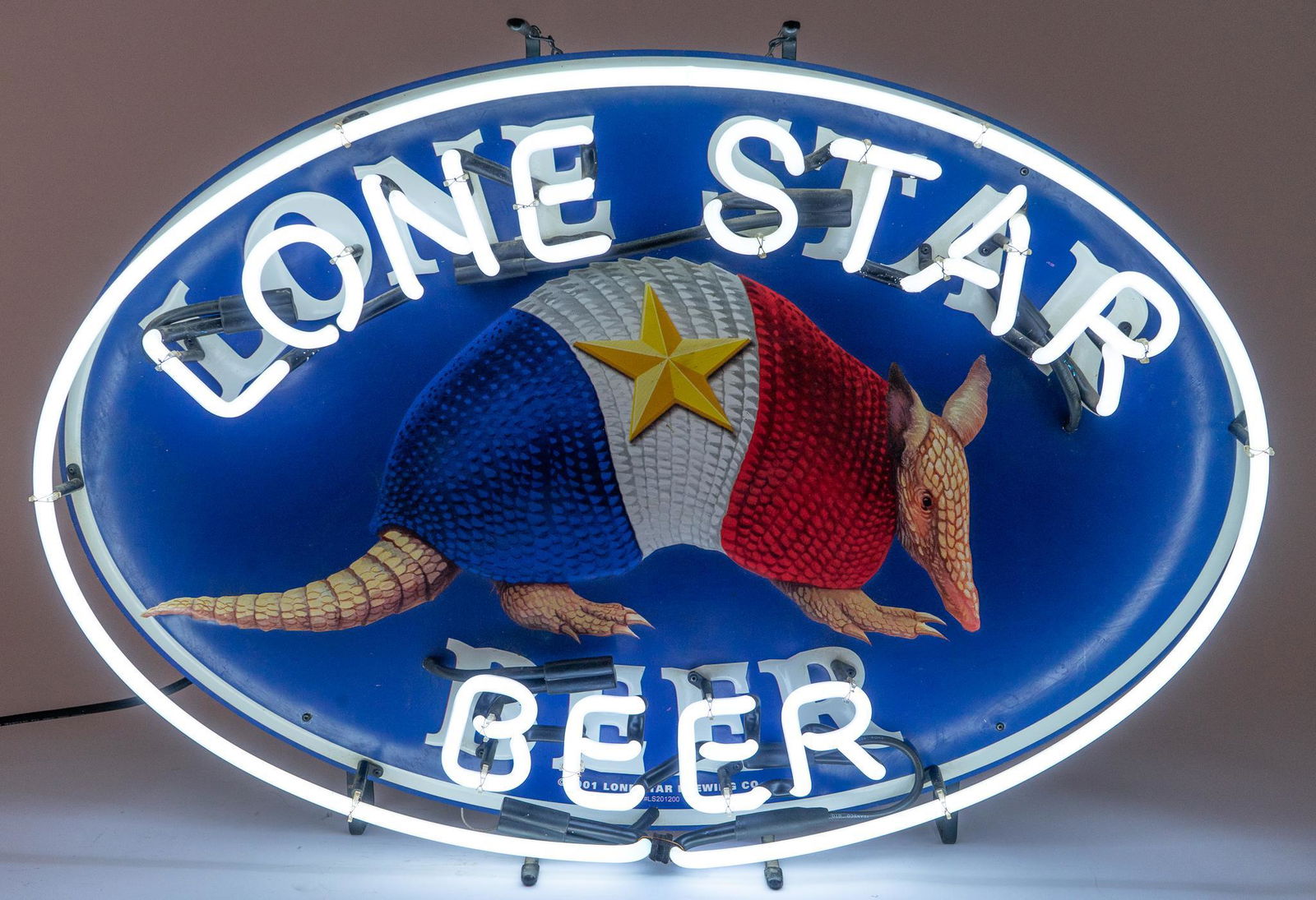 Lone Star Armadillo Neon Sign: Lone Star Beer neon advertising sign, with oval border, white lettering reading "LONE STAR / BEER", curved around center acrylic armadillo, with Texas flag body, supported on metal stand, wiri