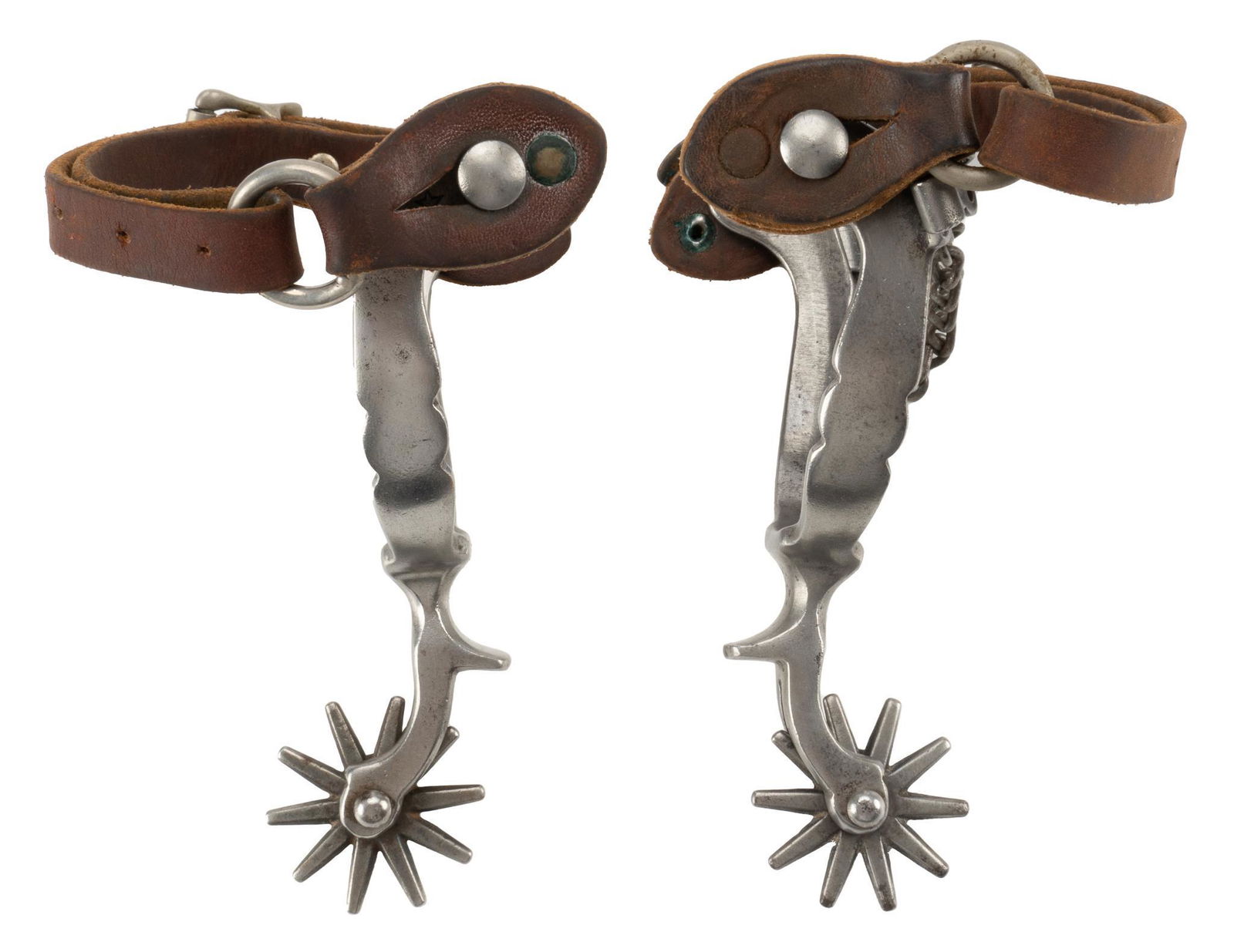 Iron Cowboy Spurs: Iron cowboy spurs, attributed to August Buermann, leather straps, missing one heel chain, 10 point rowels height 1 in. x width 4 in. x depth 10 in. Provenance: An Alamo Heights, Texas collection We
