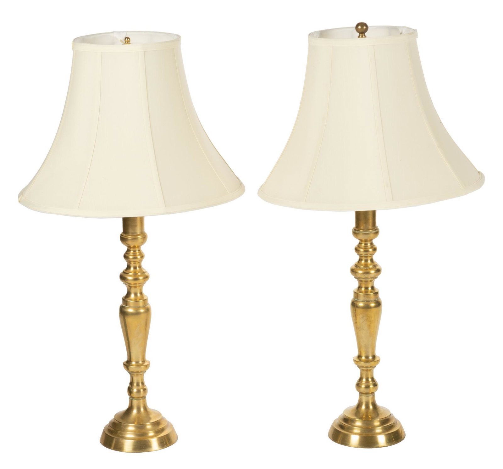 Pair of Brass Lamps: Pair of brass lamps, with candlestick style bases and white lampshades, in working condition height 33 in. x diameter 17 in. / each Provenance: A San Antonio, Texas collection We happily provide seaml