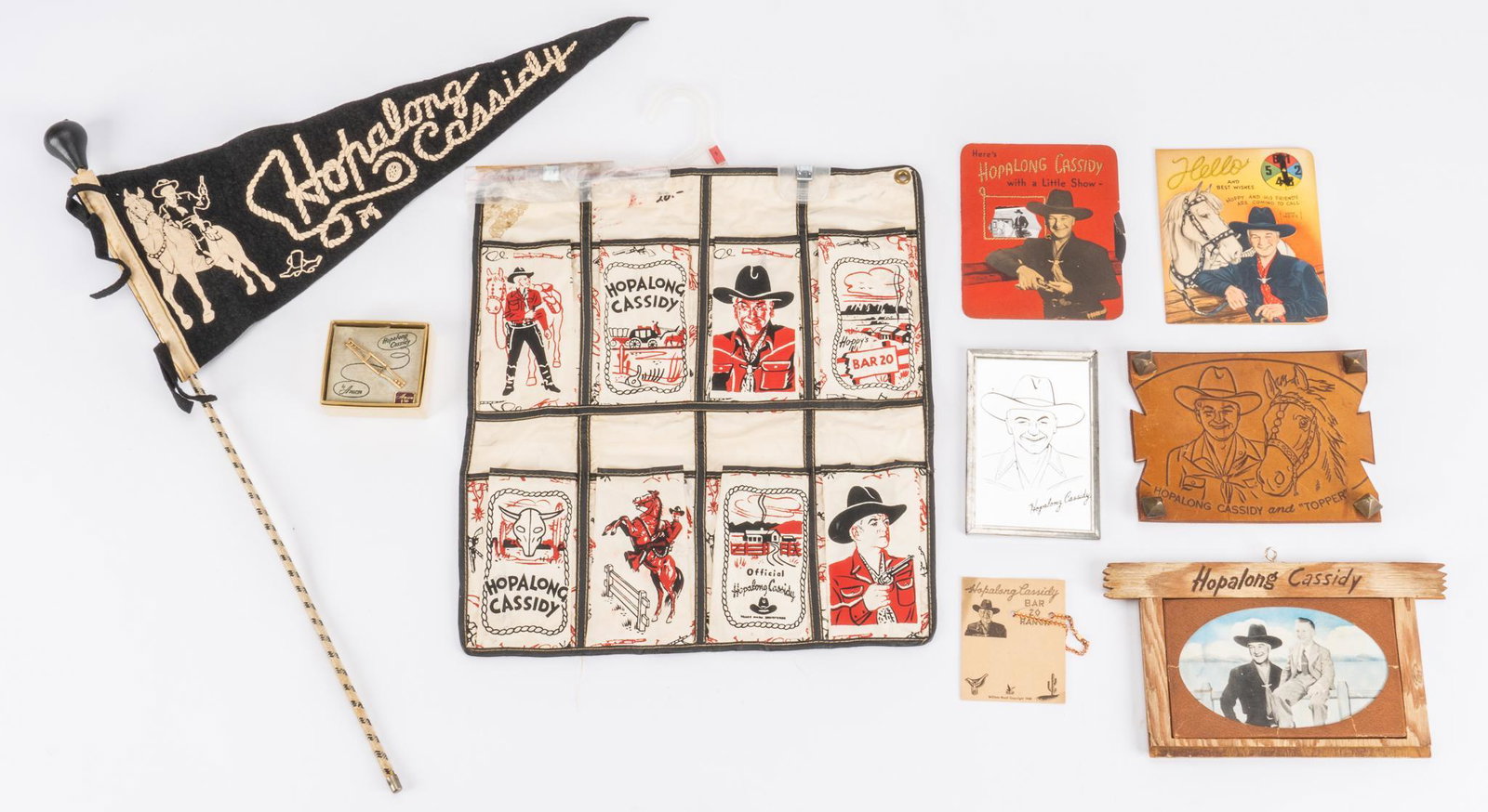 (9) Hopalong Cassidy Collectibles: Collection of nine (9) Hopalong Cassidy (the fictional cowboy hero created in 1904 by the author Clarence E. Mulford) collectibles to include flag and collectible cards height 16 in. x width 14.5 in. 
