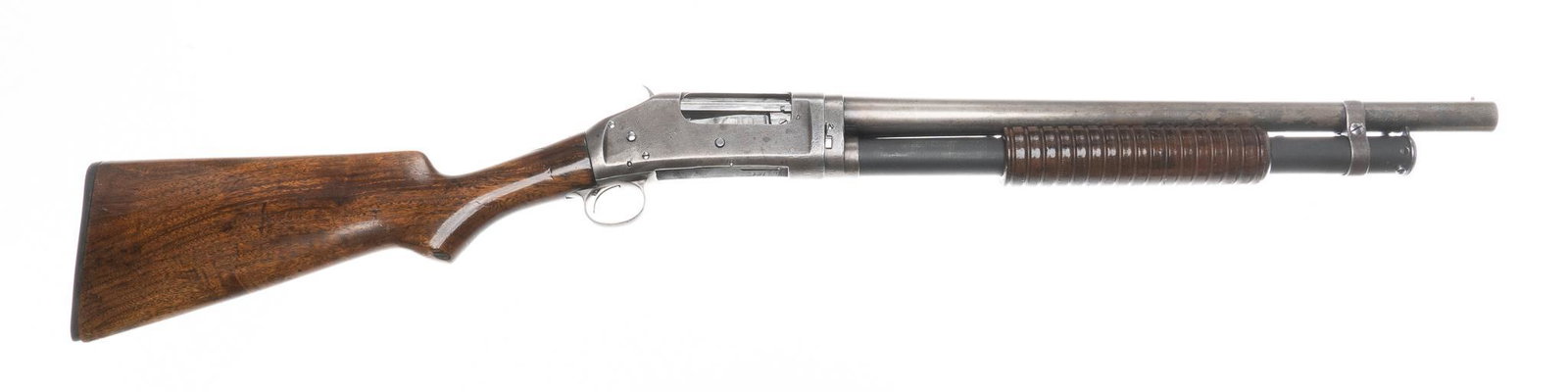 Winchester Model 1897 12-Gauge Pump-Action Shotgun: Serial: 665385 Manufacturer: Winchester Repeating Arms Co. (c. 1900) Model: 1897 Caliber: 12 Ga. Barrel length: 18.5" OAL: 36" Condition: Good; the wood stock shows handling marks, there is a slight c
