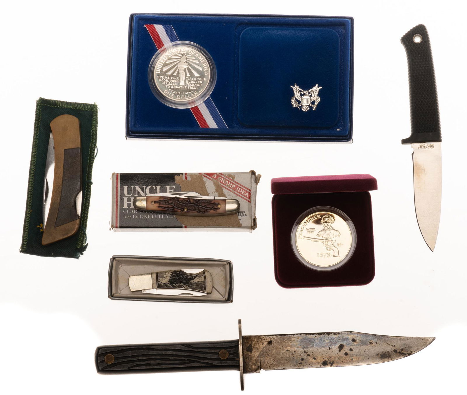 Lot of Misc. Knives & Coins: Includes: (1) 1986 Liberty Silver Dollar, 0.900 fine silver, 0.77ozt.; (2) NRA Colt Peacemaker Proof Coin, 24k gold plate over cupro-nickel; (3) Uncle Henry 807UH J.R. pocket knife; (4) Japanese Surgi