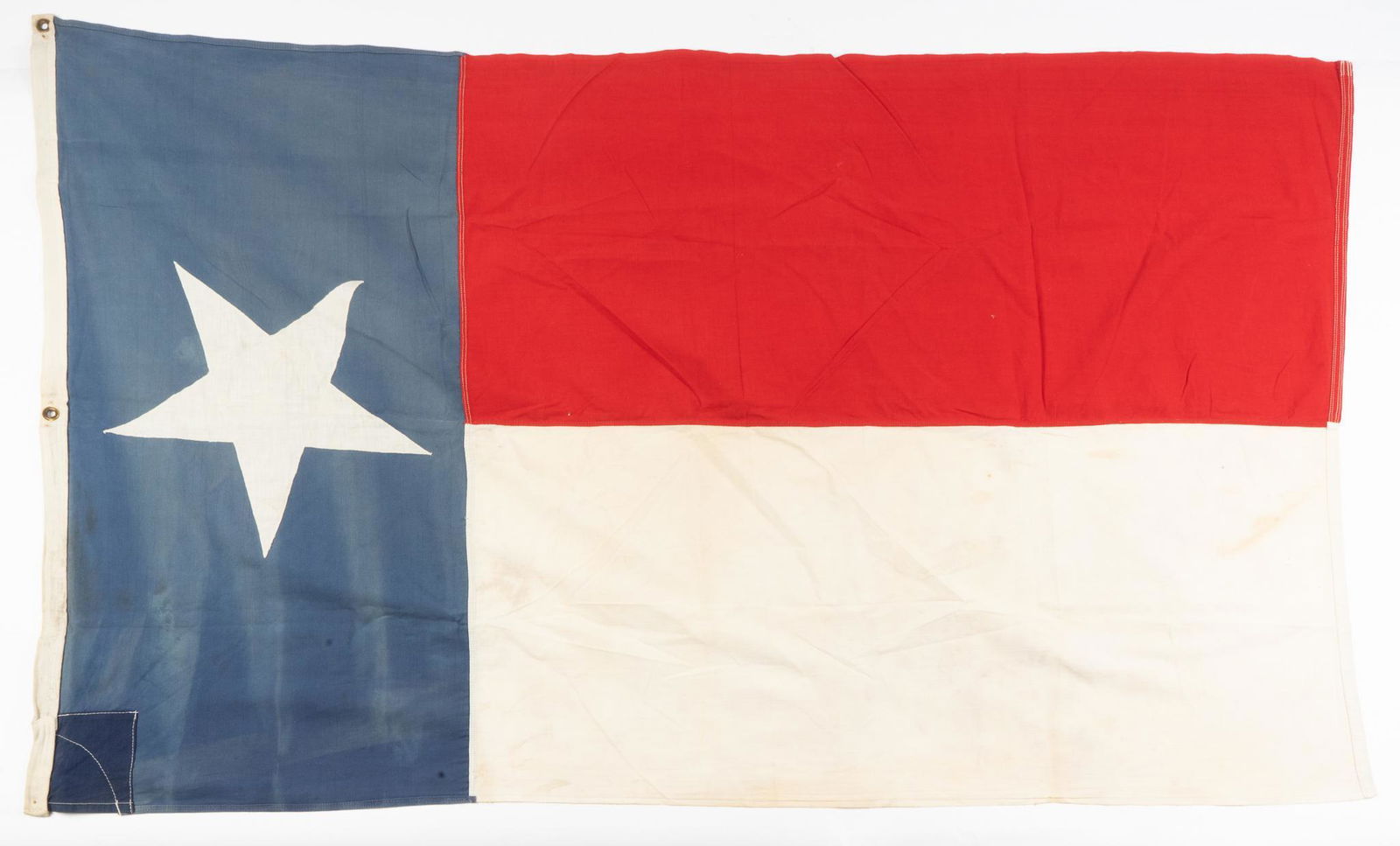 Vintage Texas Flag: Includes: -c. 1940s Cotton Texas Flag Dimensions: 36 x 56" Condition: No markings along back of seam, repair made to top Provenance: A San Antonio, Texas estate We will happily provide seamless shi