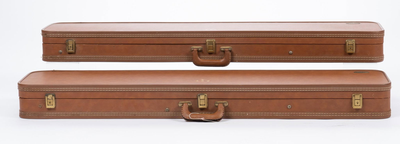 Pair of Vintage Browning Leather Hard Cases: Marked: Browning; each initialed w/ Gothic Print Measures: 47.25 x 10.5 x 4.5" Condition: Good; used w/ light wear on each Includes: white fleece lining on the top Provenance: A San Antonio, Texas Est