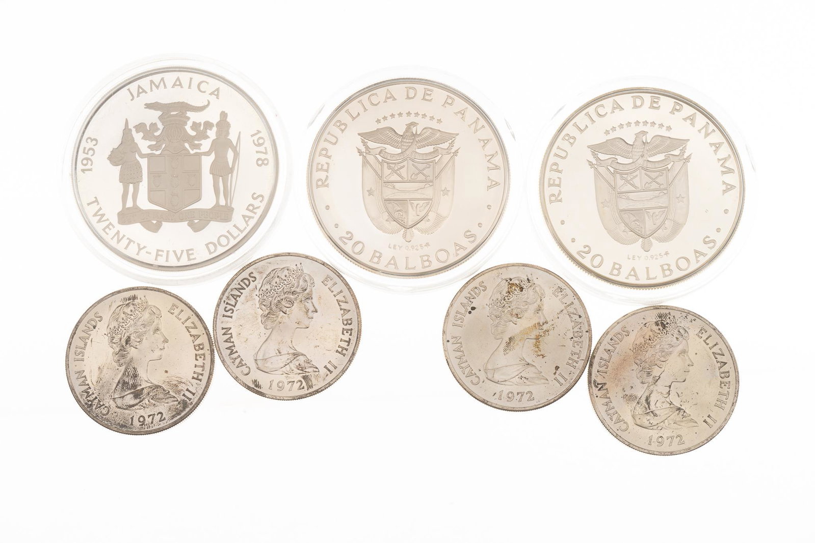 Collection of 7 Large Caribbean Silver Coins: Includes: 1 Jamaican 25 dollar silver coin 4.365 Ozt 2 Panamanian 20 Balboa coins 4.195 Ozt (each) 4 Cayman Islands 25 dollar coins 1.665 Ozt (each)