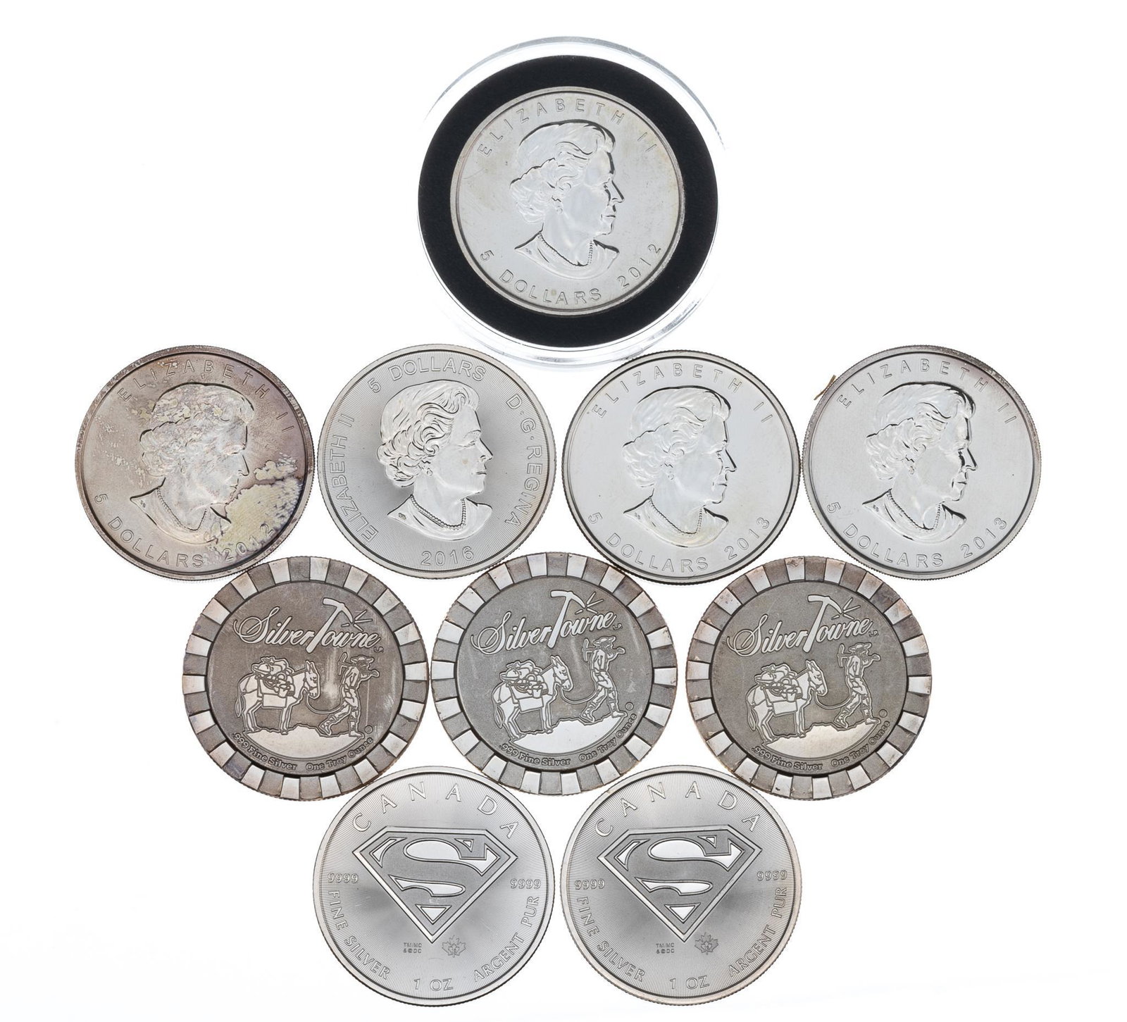 Collection of 10 International Silver Coins: Includes: -5 Canadian silver 1oz. coins -3 "Silver Towne" silver 1oz. coins -2 Canadian Superman Marked silver 1oz. coins Provenance: A San Antonio, Texas estate Nationwide in-house shipping i