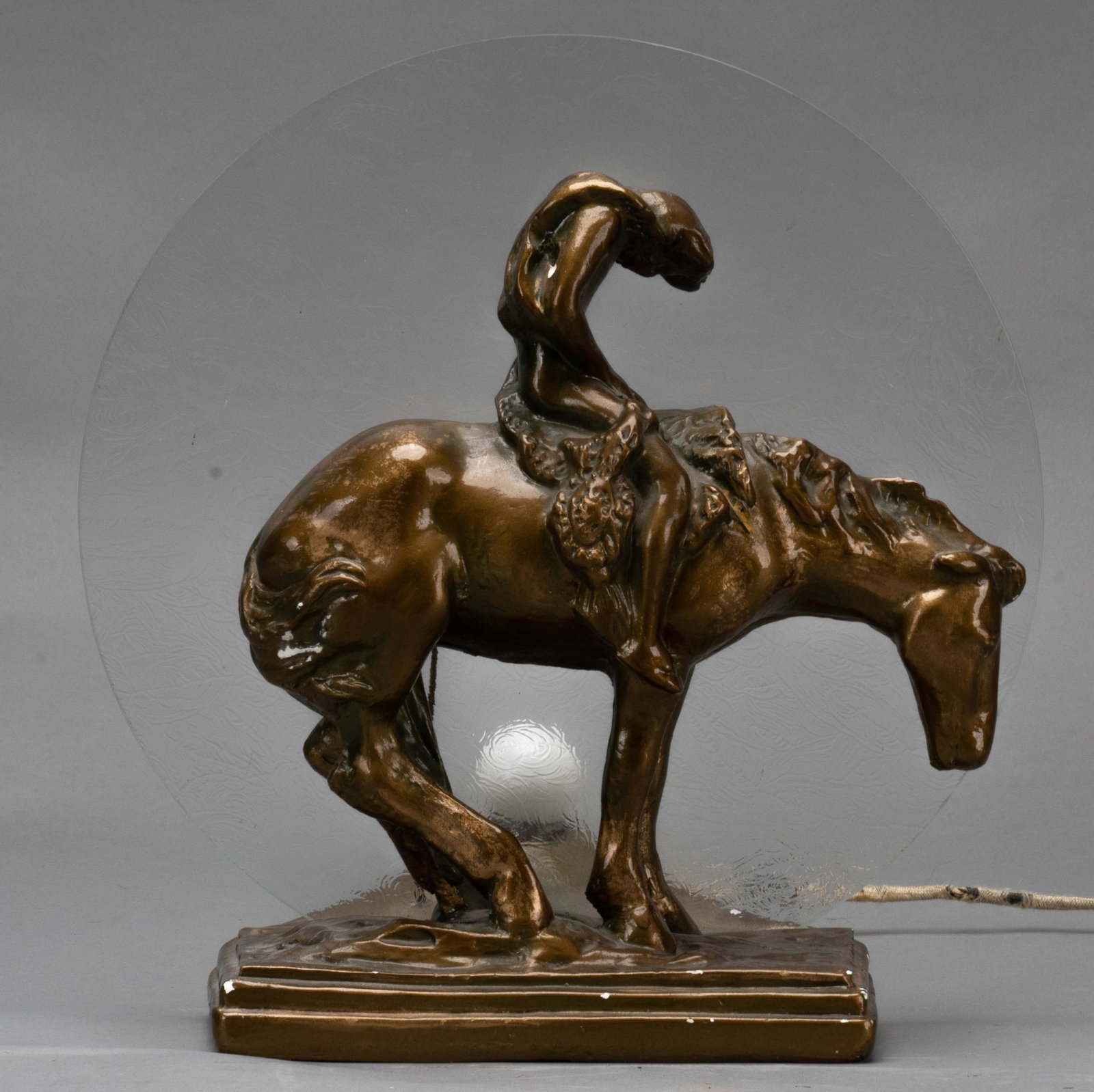 The End of the Trail Lamp: Lamp with sculpture as a nod to James E. Fraser's "The End of the Trail" sculpture, with glass disc and bulb, working condition height 13 in. x width 12 in. x depth 8.5 in. Provenance: An 