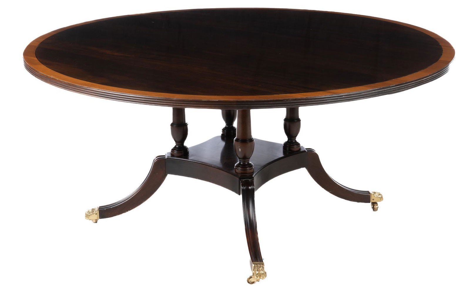 Sheraton Style Dining Table: Sheraton style dining table, with round top, veneer inlay border, supported on turned pedestal base, ending in four saber legs with casters, featuring lion paws height 30 in. x width 66 in. x depth