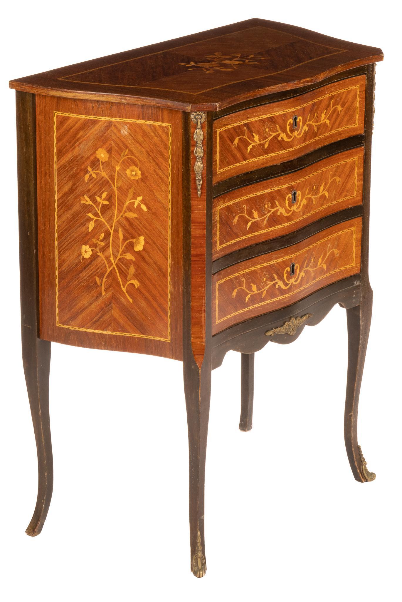 Marquetry Wood Commode: Wood commode with floral motif marquetry throughout, three drawers, ormolu accents, supported on cabriole legs height 30 in. x width 24 in. x depth 13 in. We happily provide seamless shipping servic