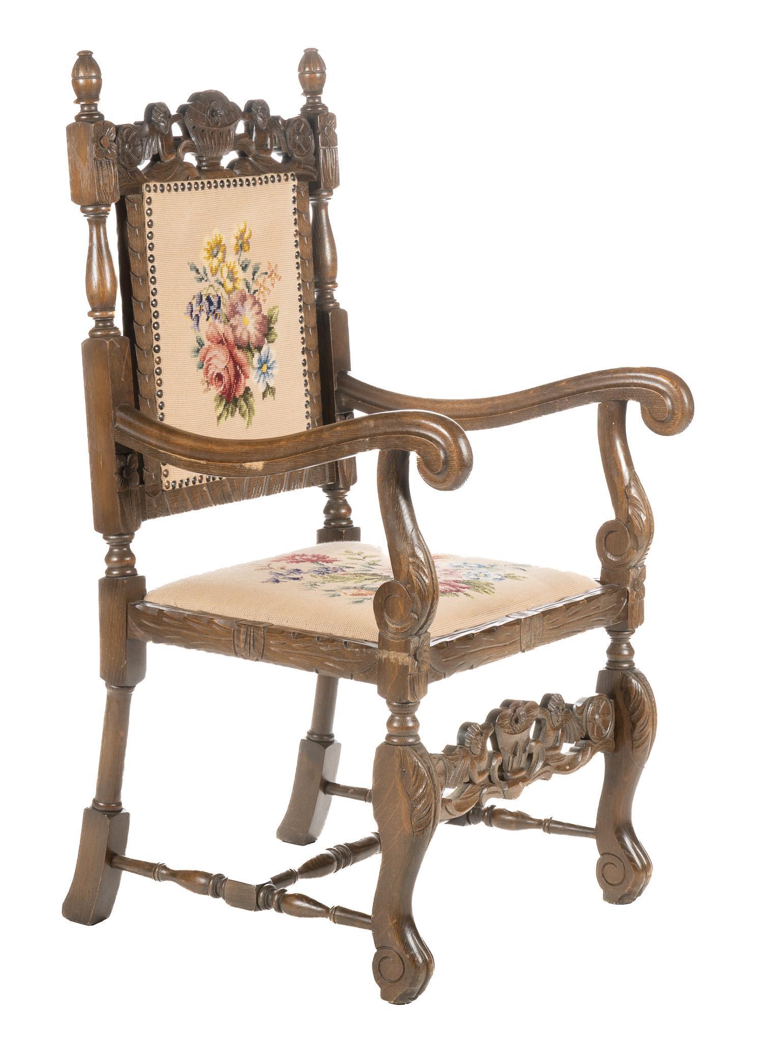 Needle Point Armchair: Vintage needlepoint armchair, featuring carved cherub crest, urn finials, supporting upholstered seat and back with needlepoint florals, supported on scroll legs connected with front stretcher height 