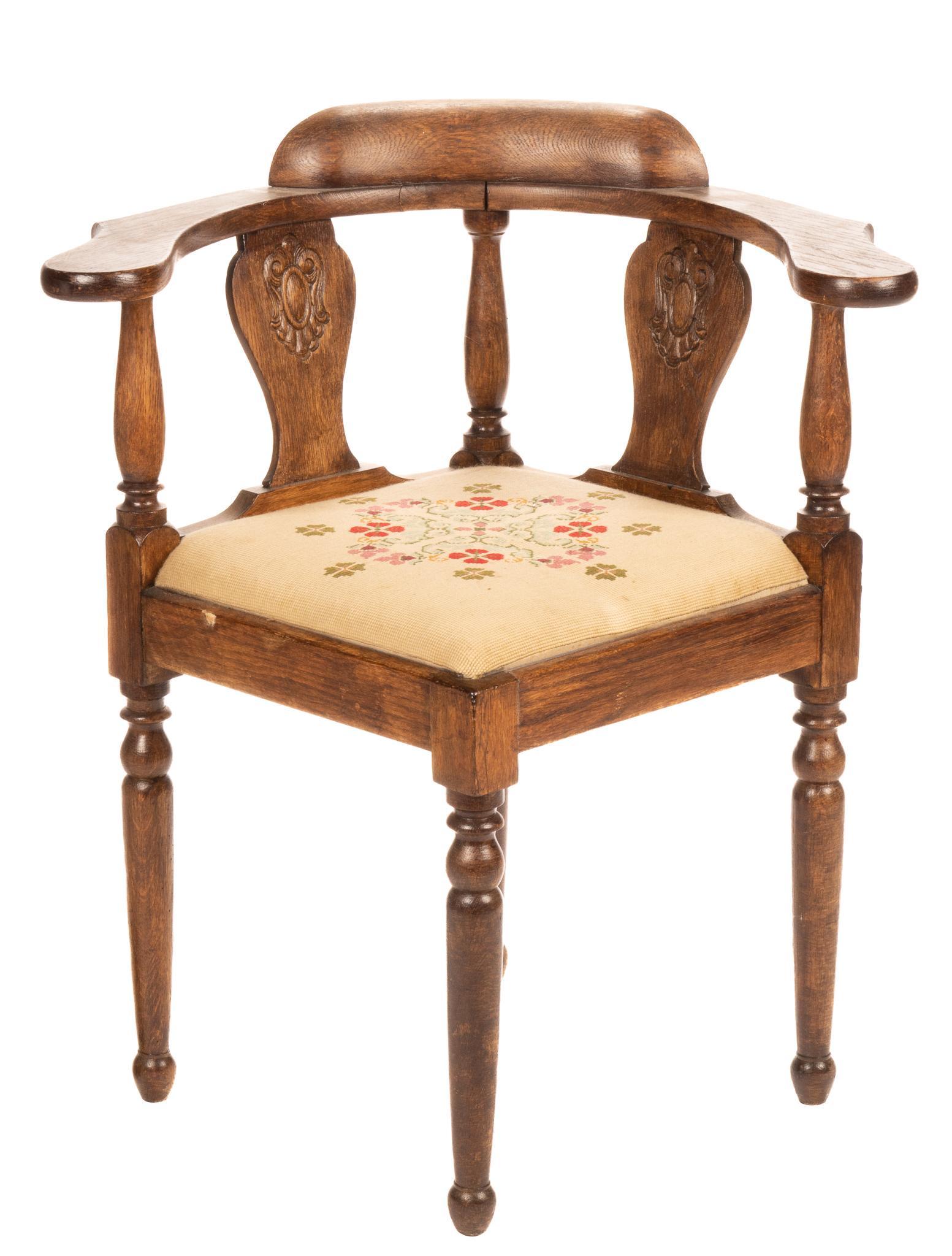 Corner Chair: Corner chair, with needlepoint flower upholstered seat, round back, having paddle arms, carved dual splats, supported on tapered legs height 32 in. x width 25 in. x depth 25 in. We happily provide