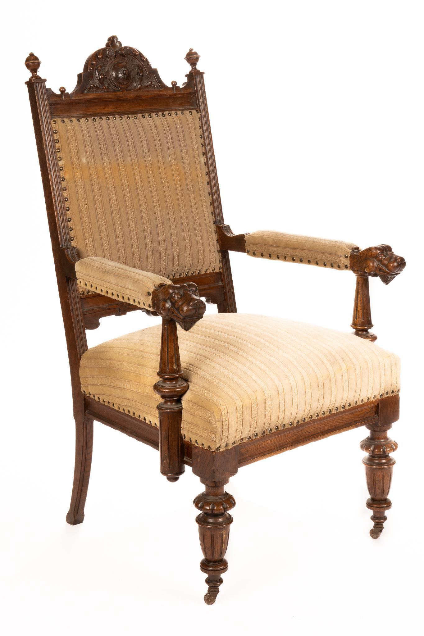 Eastlake Style Dining Chair: Eastlake style dining chair, with beige striped upholstery, architectural arched crest, flanked by urn finials, featuring carved canine head arm rests, supported on fluted legs, ending in casters heig