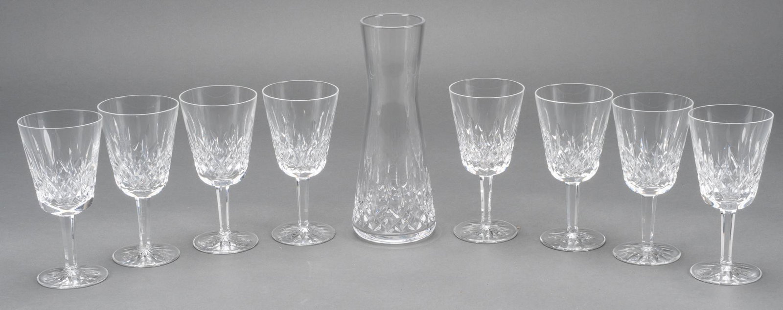 Waterford "Lismore" Crystal Water Goblets: Eight (8) water or red wine goblets in the "Lismore" pattern from Waterford Crystal; also includes Lismore Nouveau Uptown Carafe. Goblets height 6 7/8 in., carafe 10 in. Provenance: a San Anto