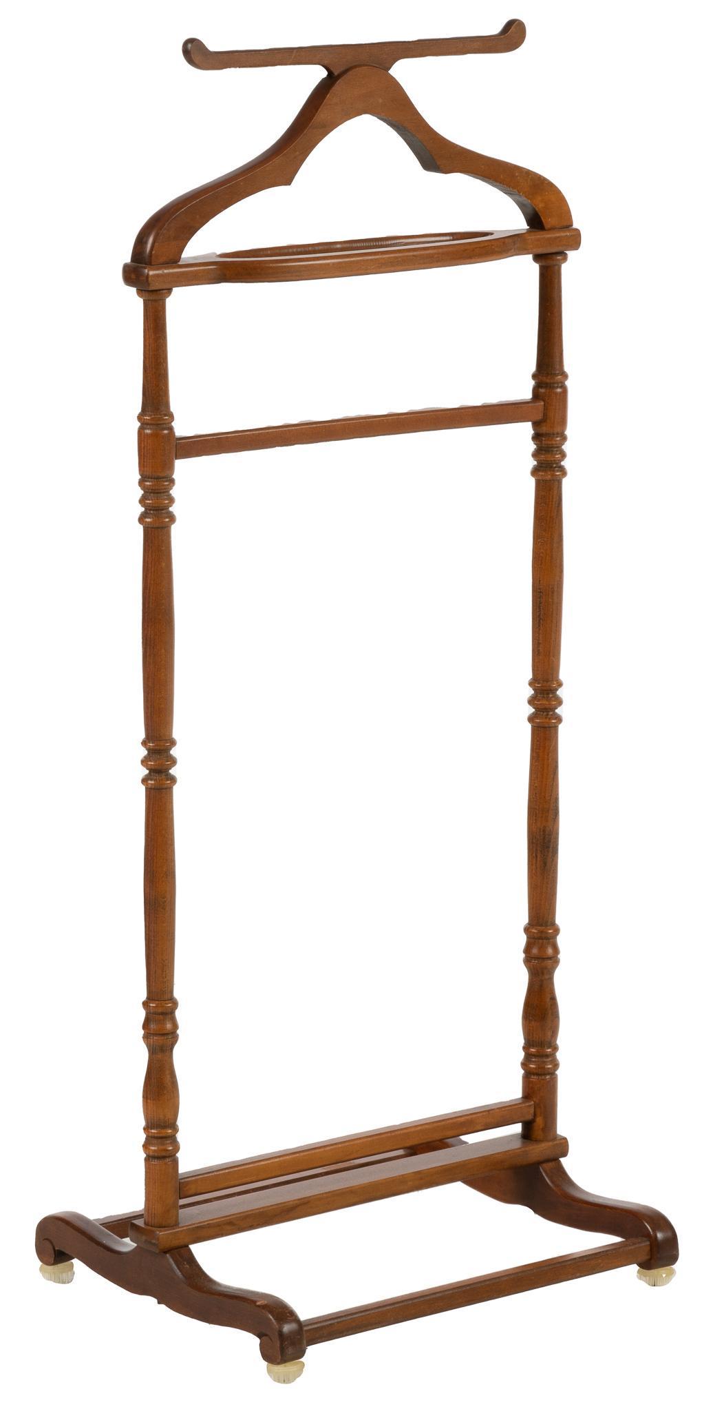 Valet Stand: Wood valet stand, with turned supports on a stretchered wood base with scrolled feet height 33.5 in. x width 19 in. x depth 15 in. Provenance: the Estate of a former McNay Museum curator, Jean Willi