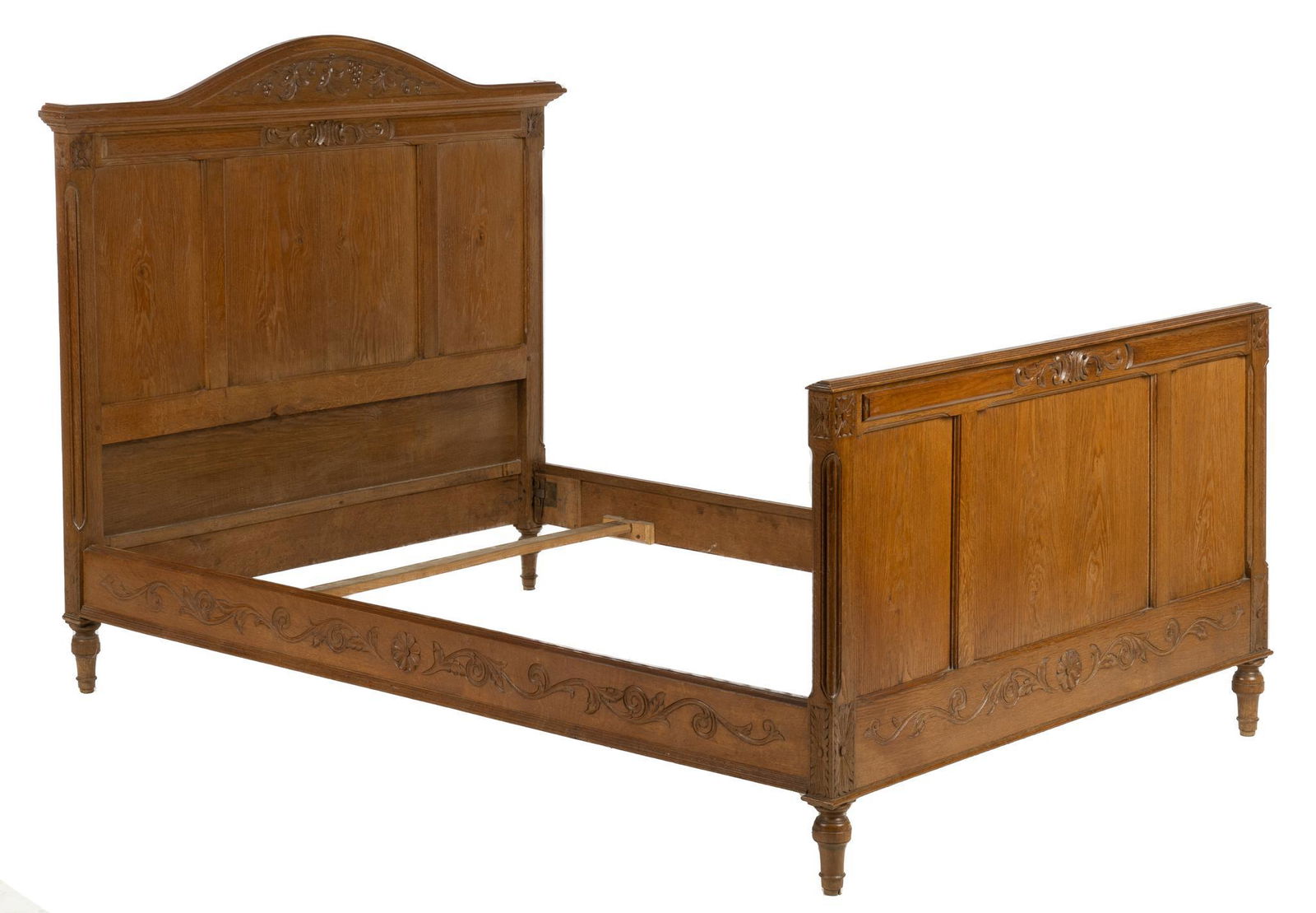 Carved Bed: Carved bedframe, carved throughout with floral and botanical motifs including grapevines on the headboard, supported on turned feet height 53 in. x width 58 in. x depth 80 in. / overall width 51 in.