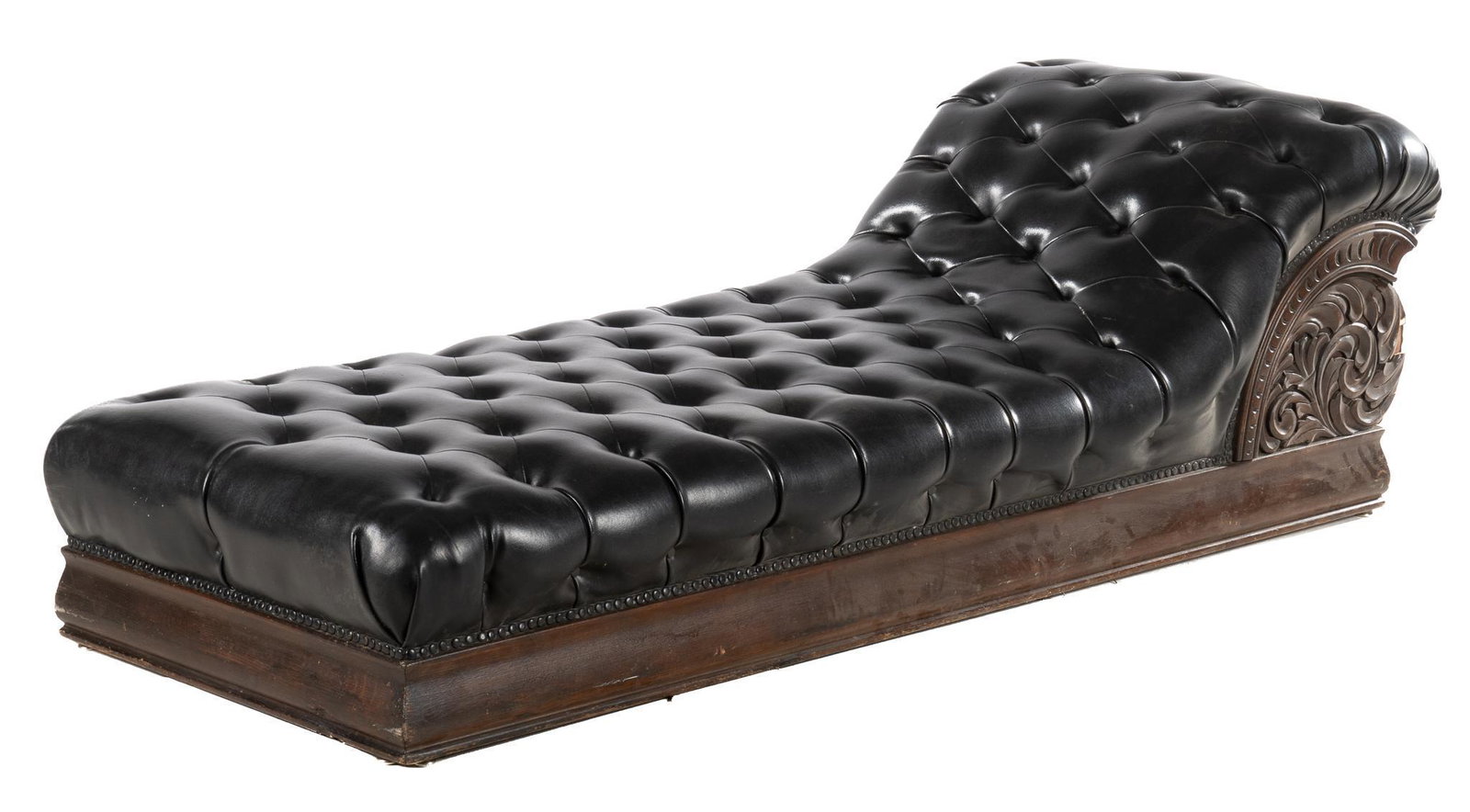 Chaise Lounge: Chaise lounge, with black tufted upholstery, wood frame with carved botanical motifs on side height 25 in. x 79 in. x depth 32 in. Provenance: an Ann Arbor, Michigan collection We happily provide s