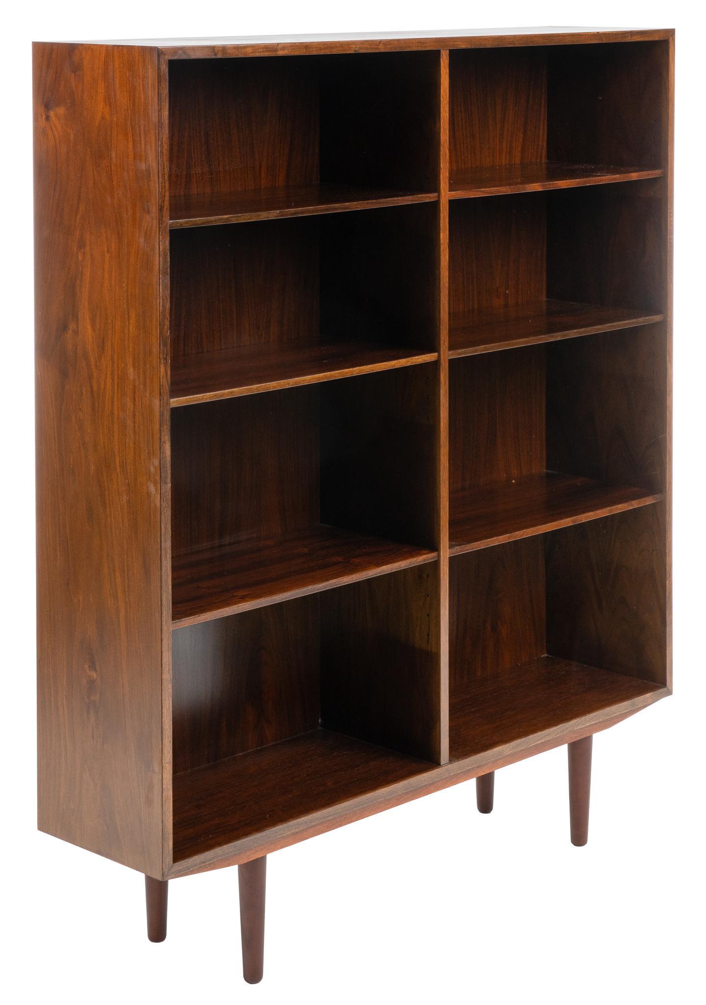 Omann Jun Mid-Century Bookcase: Danish Mid-Century rosewood bookcase, model no. 6, by Gunni Omann for Omann Jun (Denmark), with right and left sides, each having three shelves, supported on pin legs, labeled on back height 56 in. x