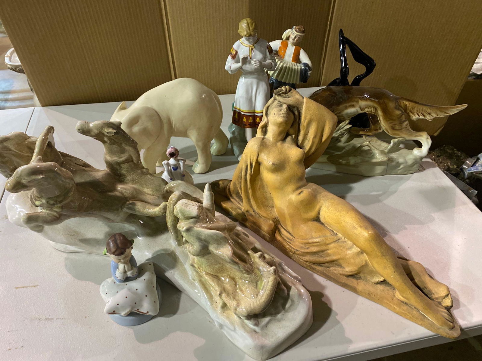 Lot of Figurines: Lot of figurines, to include an elephant figure and other animals, a reclining woman, some porcelain examples We happily provide seamless shipping services on everything we sell. Please email us at s