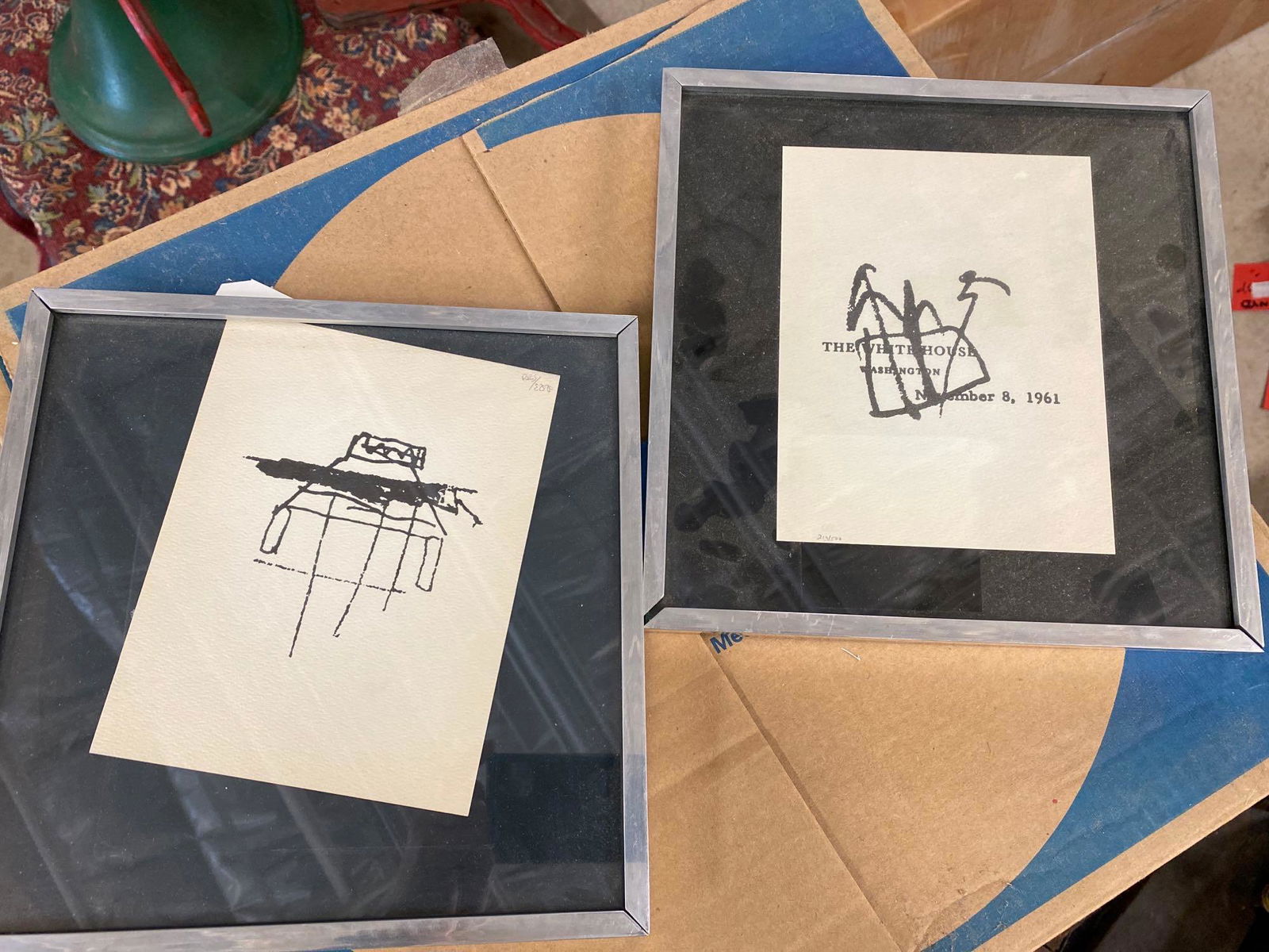Pair of JFK Doodles: Pair of small framed JFK artwork, numbered 213/500 and 233/500 We happily provide seamless shipping services on everything we sell. Please email us at shipping@vogtauction.com or call 210-971-575